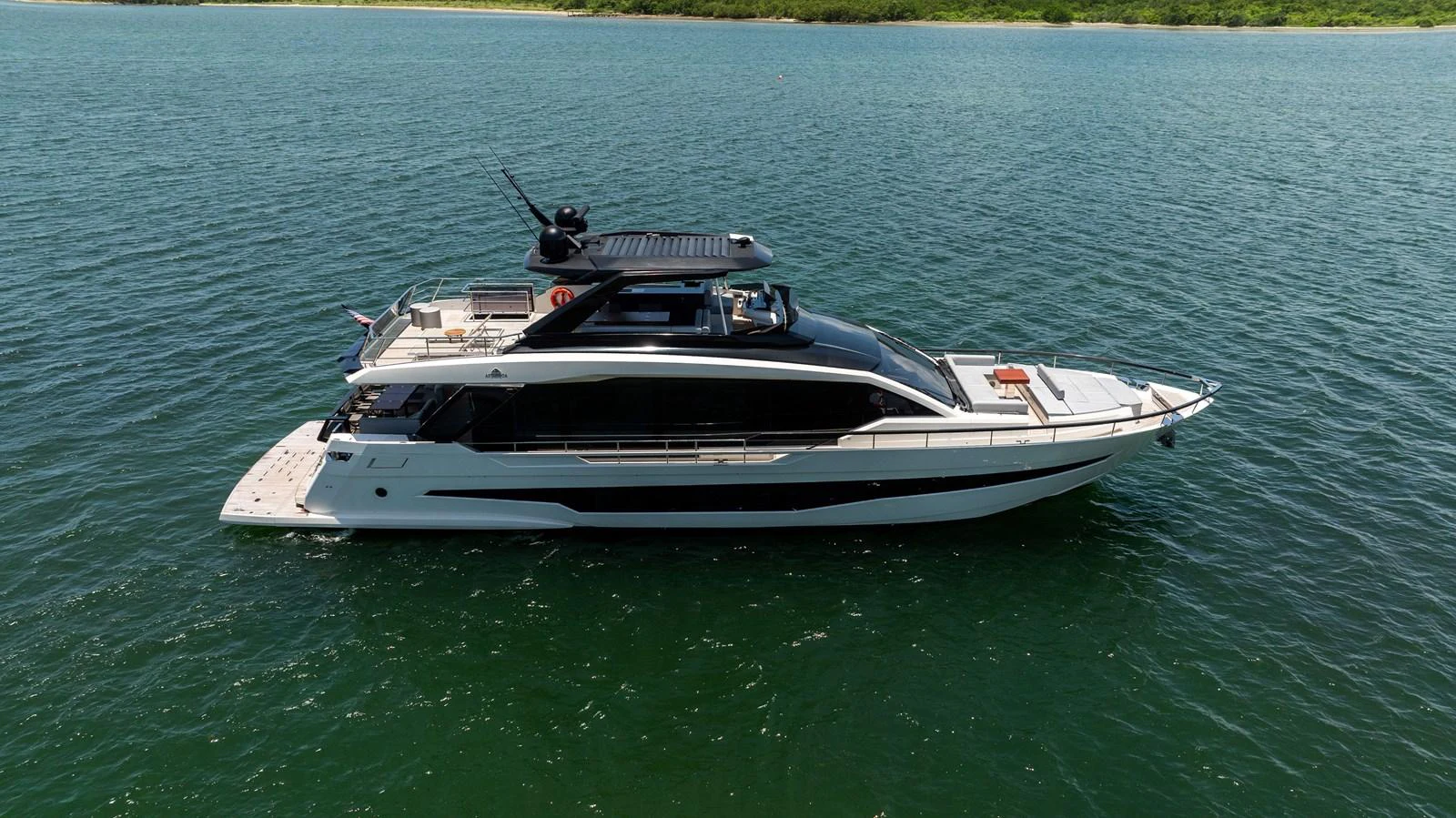 A sleek and modern yacht glides gracefully on calm waters, showcasing its elegant design. aboard HOTEL COLLECTION Yacht for Sale