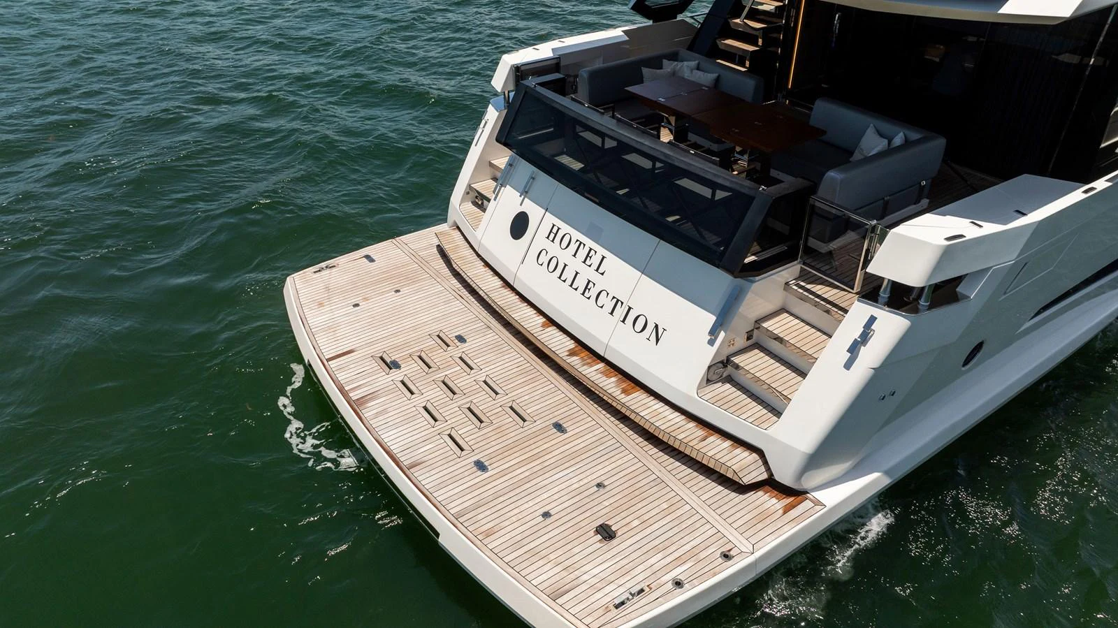 The yacht's aft deck features a spacious swim platform and elegant seating area, perfect for relaxation. aboard HOTEL COLLECTION Yacht for Sale