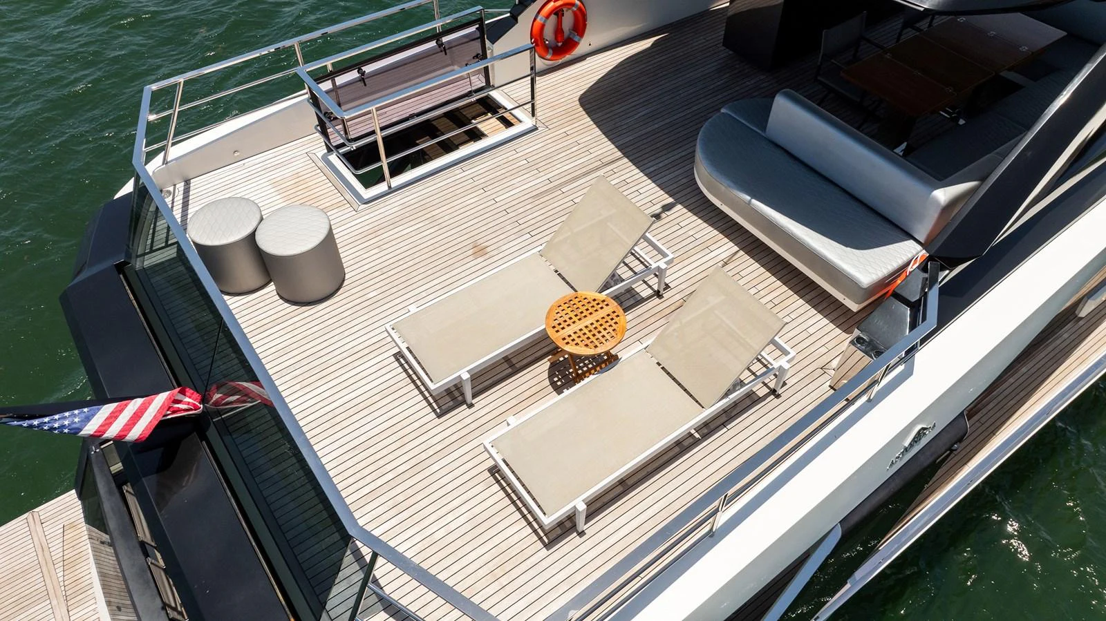 The aft deck features comfortable lounge chairs and a stylish seating area, perfect for relaxation. aboard HOTEL COLLECTION Yacht for Sale