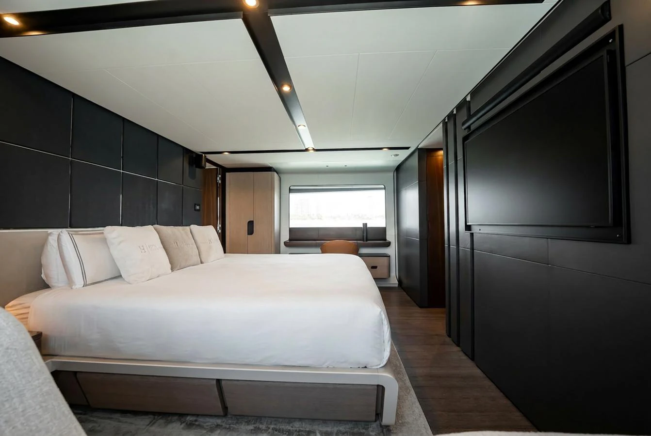 The master stateroom features a spacious bed, modern decor, and a large window for natural light. aboard HOTEL COLLECTION Yacht for Sale