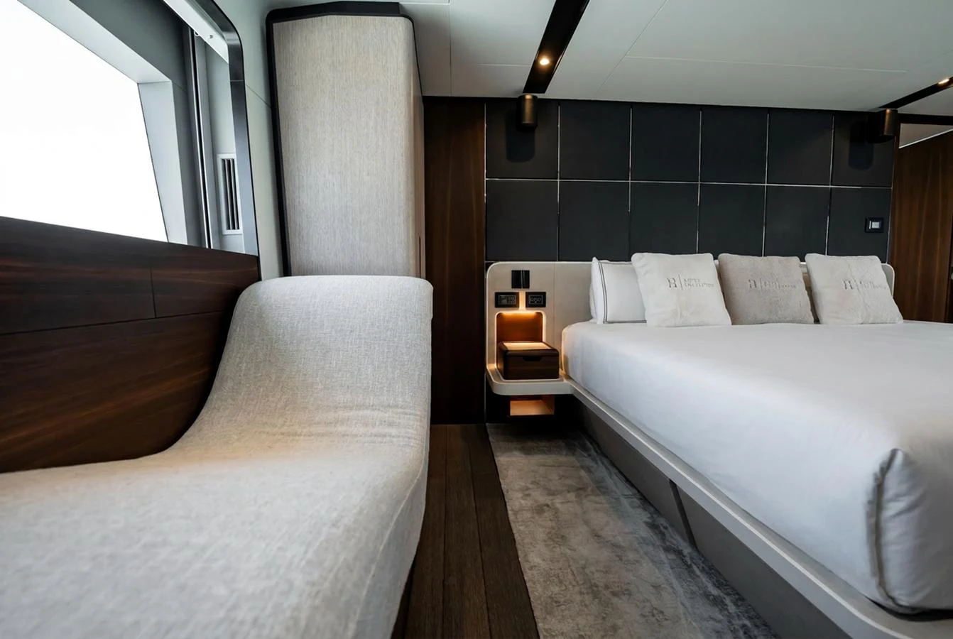The stateroom offers a serene and luxurious sleeping area with modern design elements. aboard HOTEL COLLECTION Yacht for Sale