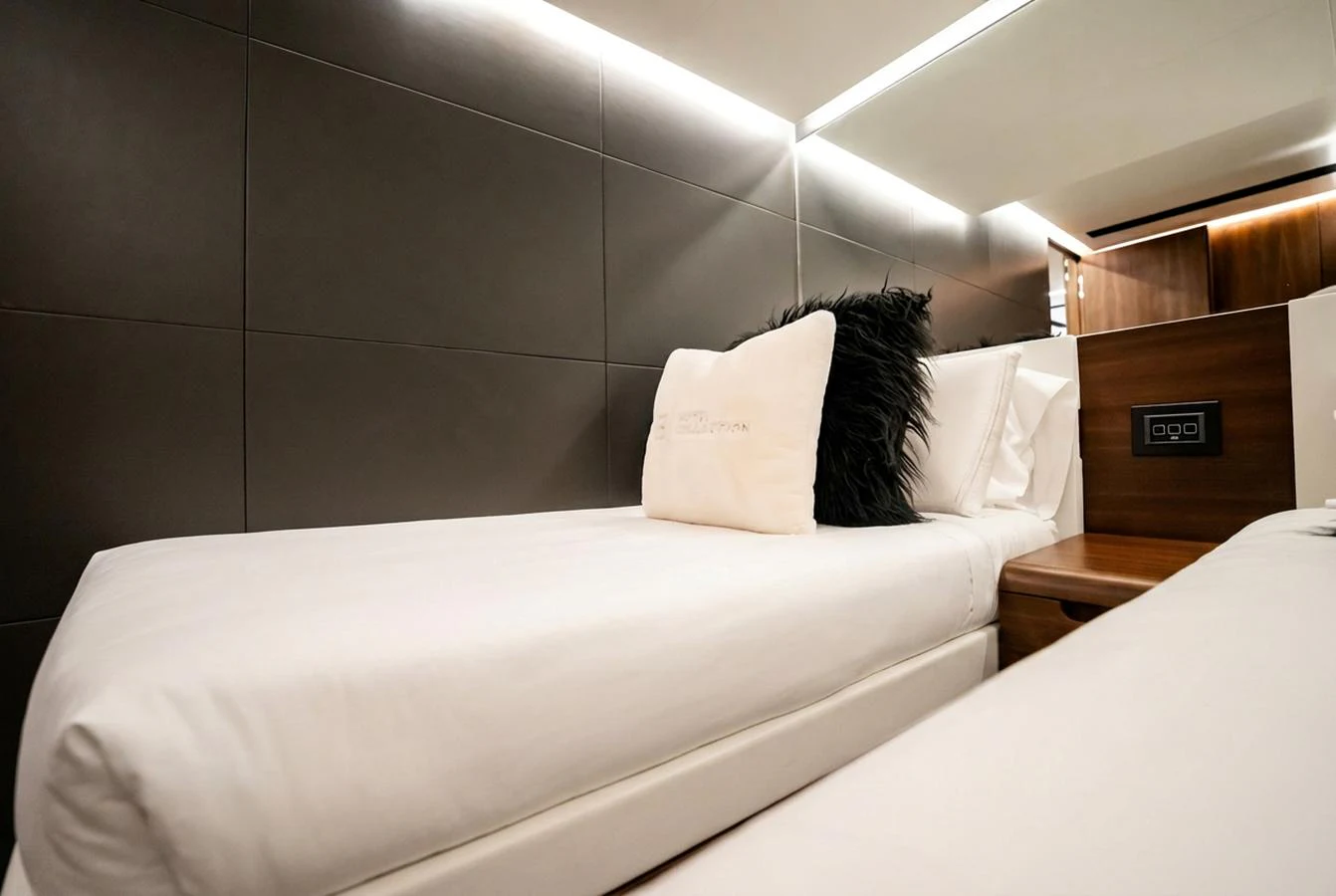 The guest stateroom features modern design with plush bedding and ambient lighting. aboard HOTEL COLLECTION Yacht for Sale