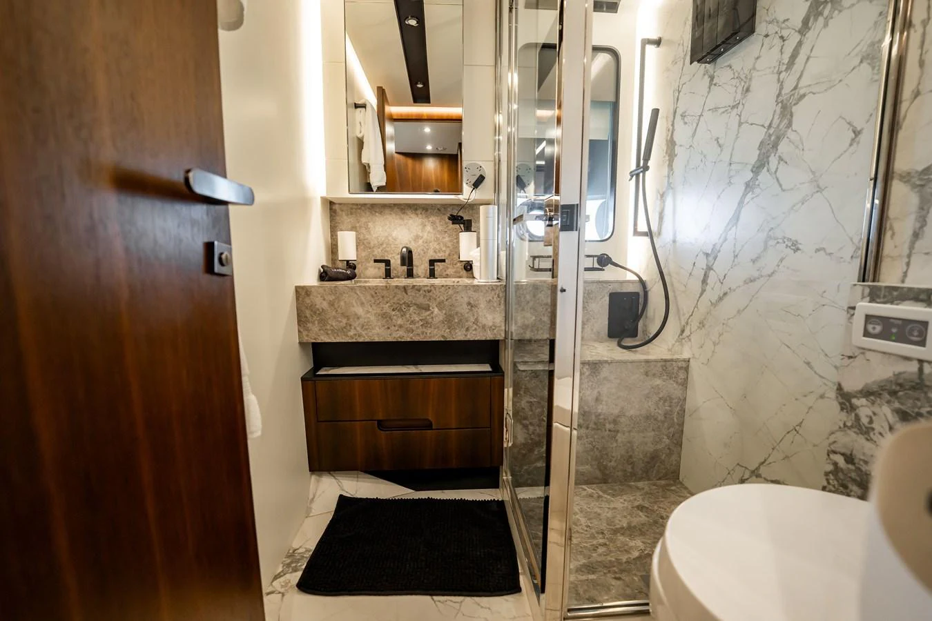 The yacht's bathroom features modern fixtures and luxurious marble accents. aboard HOTEL COLLECTION Yacht for Sale
