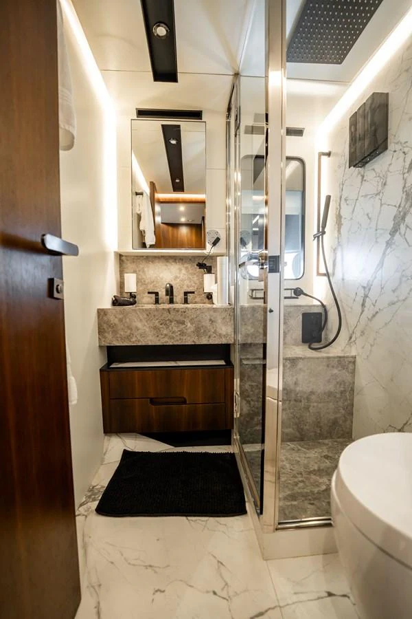 The yacht's bathroom features modern fixtures and luxurious marble accents. aboard HOTEL COLLECTION Yacht for Sale