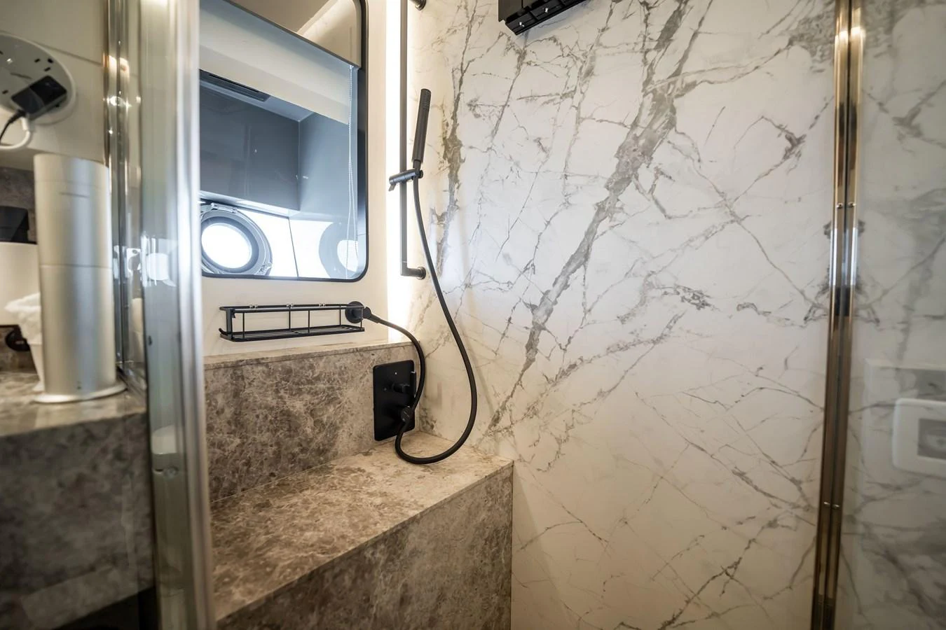 The yacht's bathroom features luxurious marble walls and modern fixtures. aboard HOTEL COLLECTION Yacht for Sale