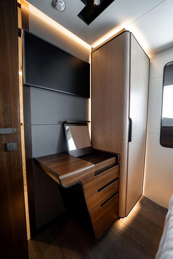 The image showcases a modern and sleek interior corner with a built-in desk and storage cabinets. aboard HOTEL COLLECTION Yacht for Sale