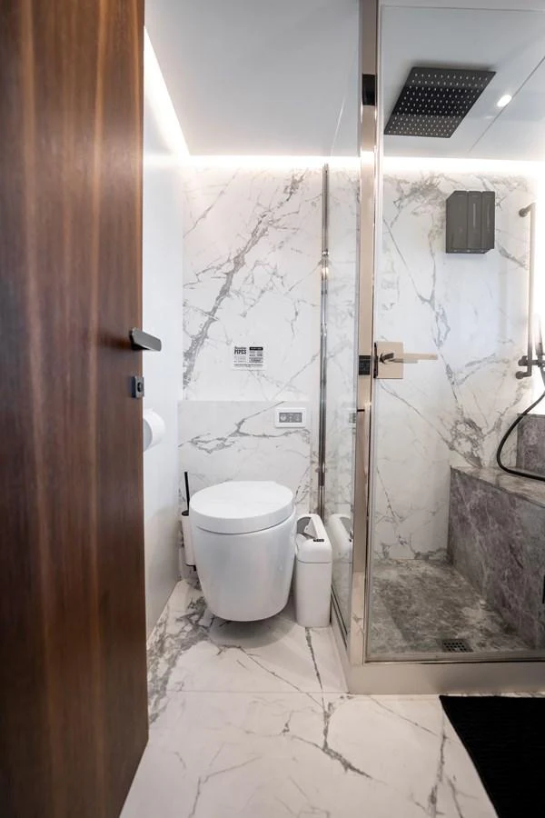 The yacht's bathroom features elegant marble surfaces and modern fixtures. aboard HOTEL COLLECTION Yacht for Sale