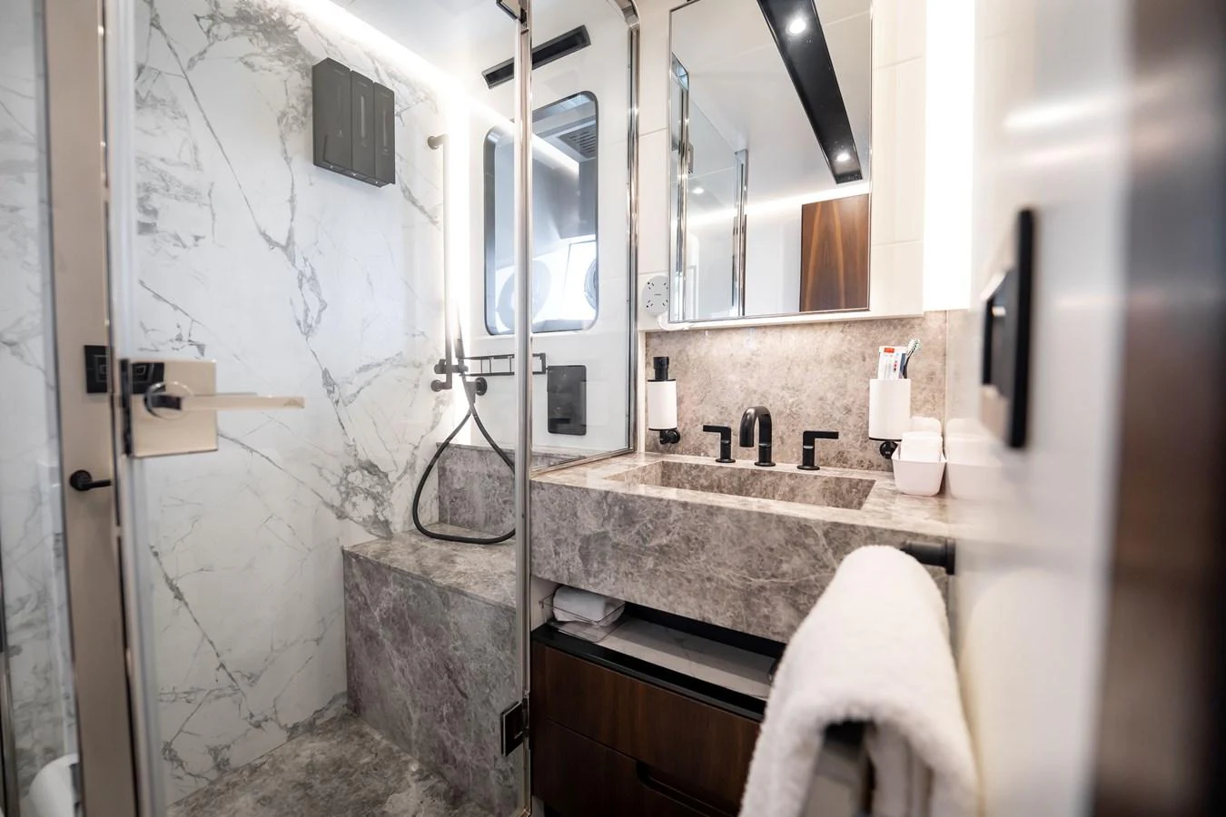 The yacht's bathroom features luxurious marble surfaces and modern fixtures. aboard HOTEL COLLECTION Yacht for Sale