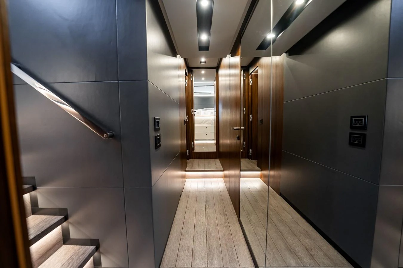 A sleek and modern hallway with wooden accents and mirrored walls. aboard HOTEL COLLECTION Yacht for Sale