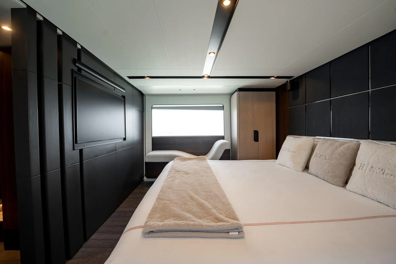 The master stateroom features a luxurious bed, modern decor, and a large window for natural light. aboard HOTEL COLLECTION Yacht for Sale
