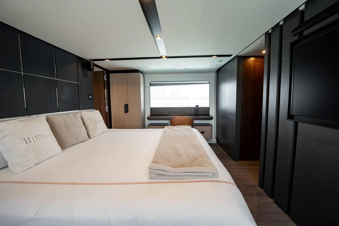 The stateroom features a luxurious bed with plush linens and a modern design. aboard HOTEL COLLECTION Yacht for Sale