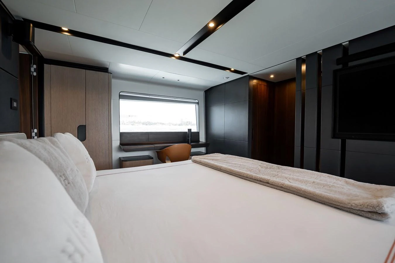 The stateroom features a luxurious bed with modern furnishings and ample natural light. aboard HOTEL COLLECTION Yacht for Sale