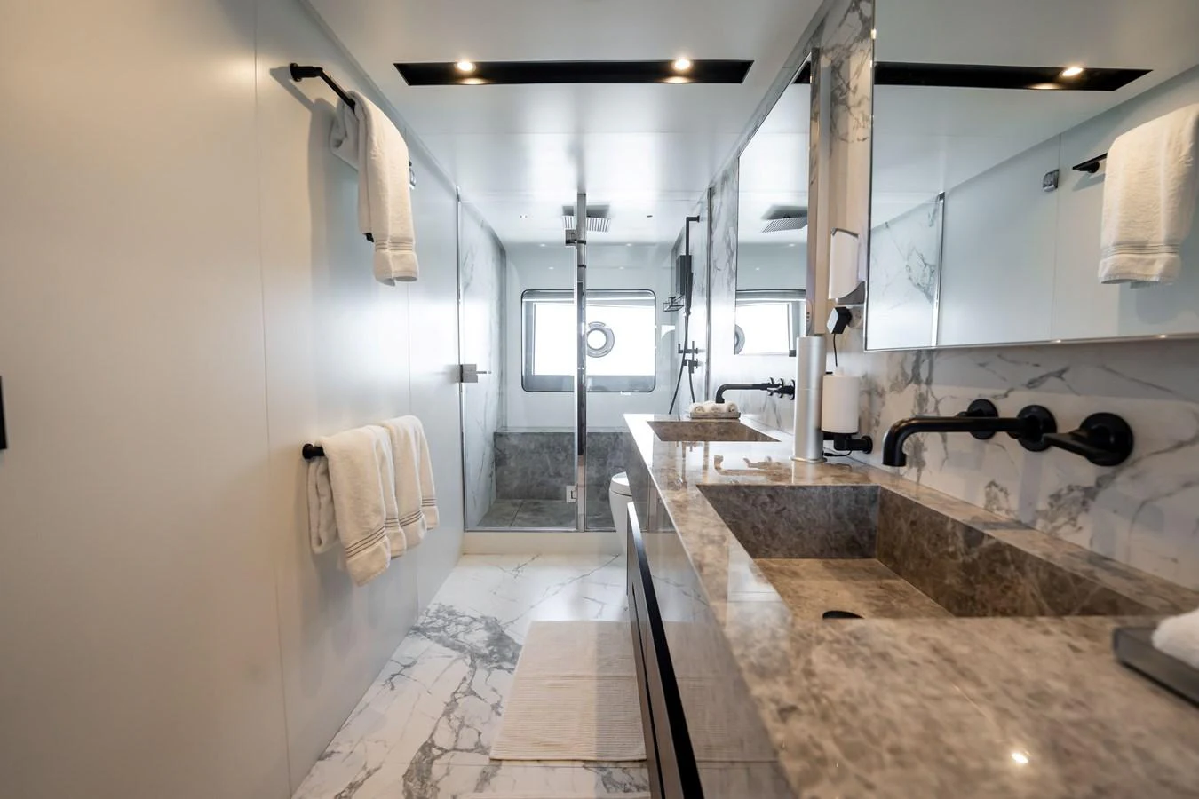 The yacht's bathroom features luxurious marble finishes and modern fixtures. aboard HOTEL COLLECTION Yacht for Sale