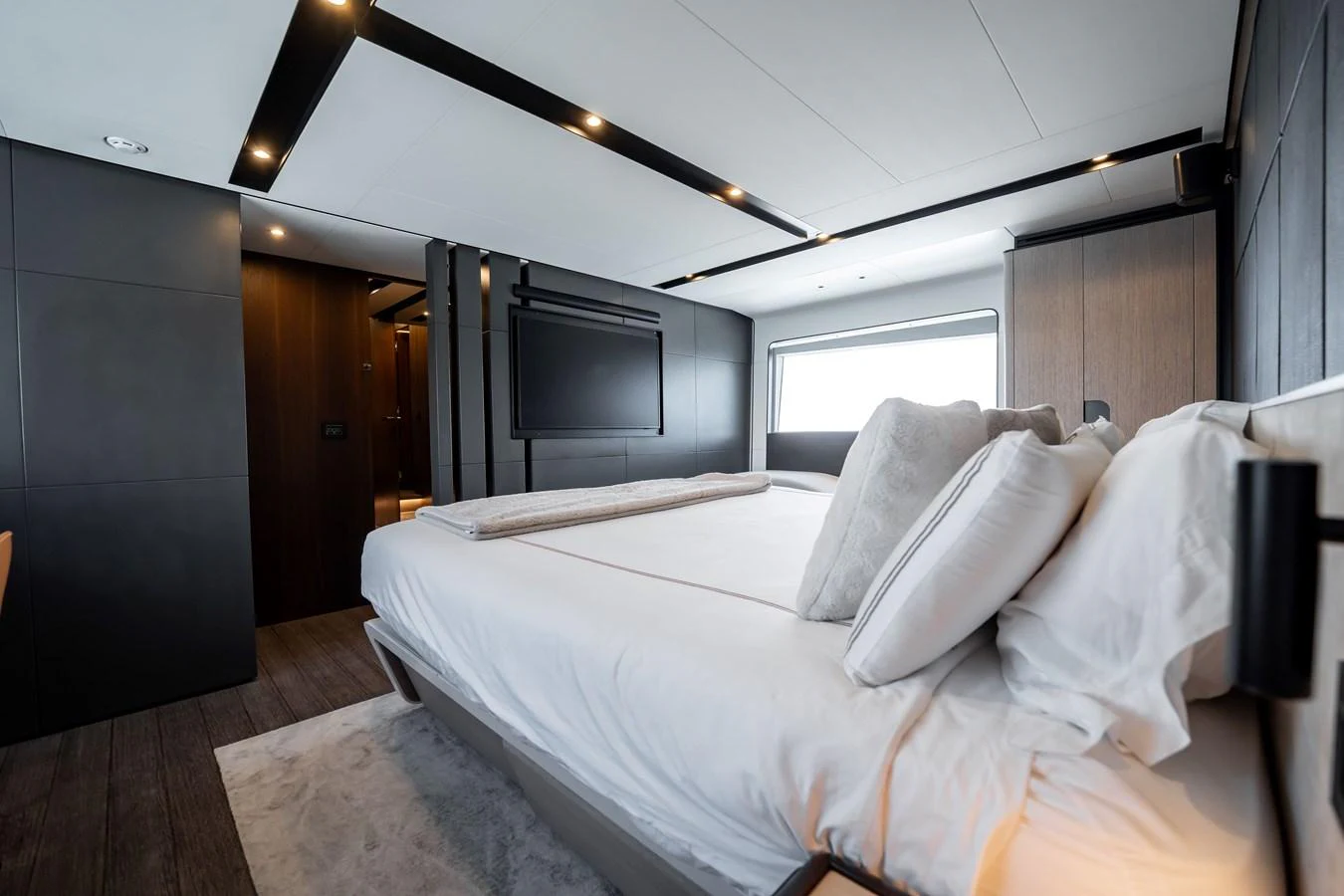 The master stateroom features a luxurious bed with modern decor and ample natural light. aboard HOTEL COLLECTION Yacht for Sale
