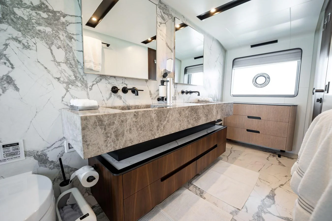 The yacht's bathroom features luxurious marble countertops and modern fixtures. aboard HOTEL COLLECTION Yacht for Sale