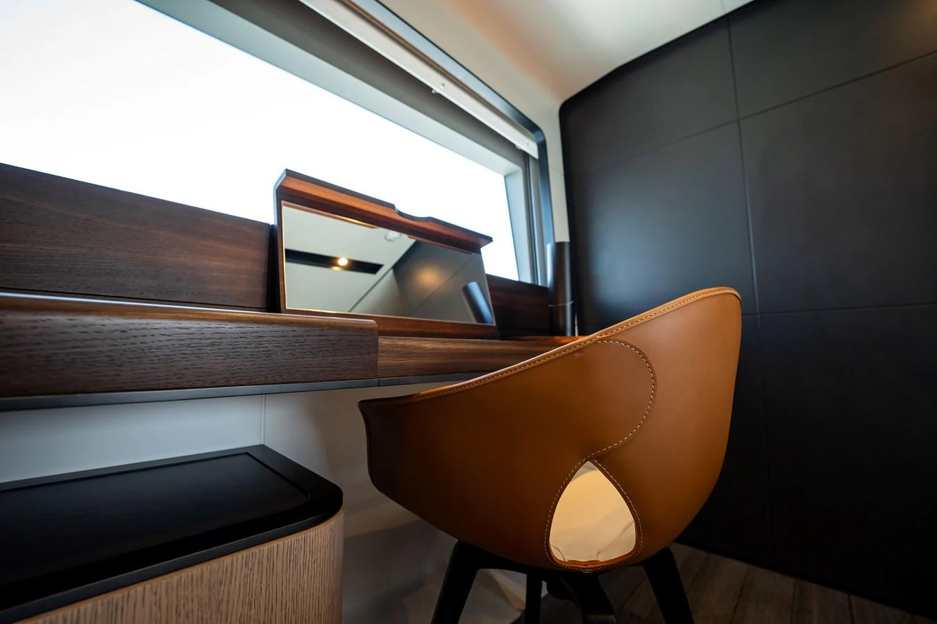 A stylish and modern workspace with a sleek desk and a comfortable leather chair. aboard HOTEL COLLECTION Yacht for Sale
