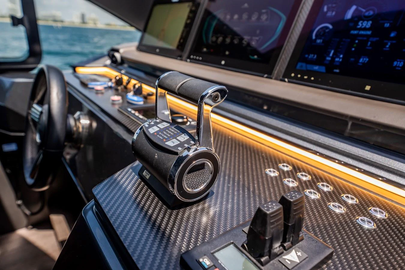 The helm station features advanced navigation controls and sleek carbon fiber accents. aboard HOTEL COLLECTION Yacht for Sale
