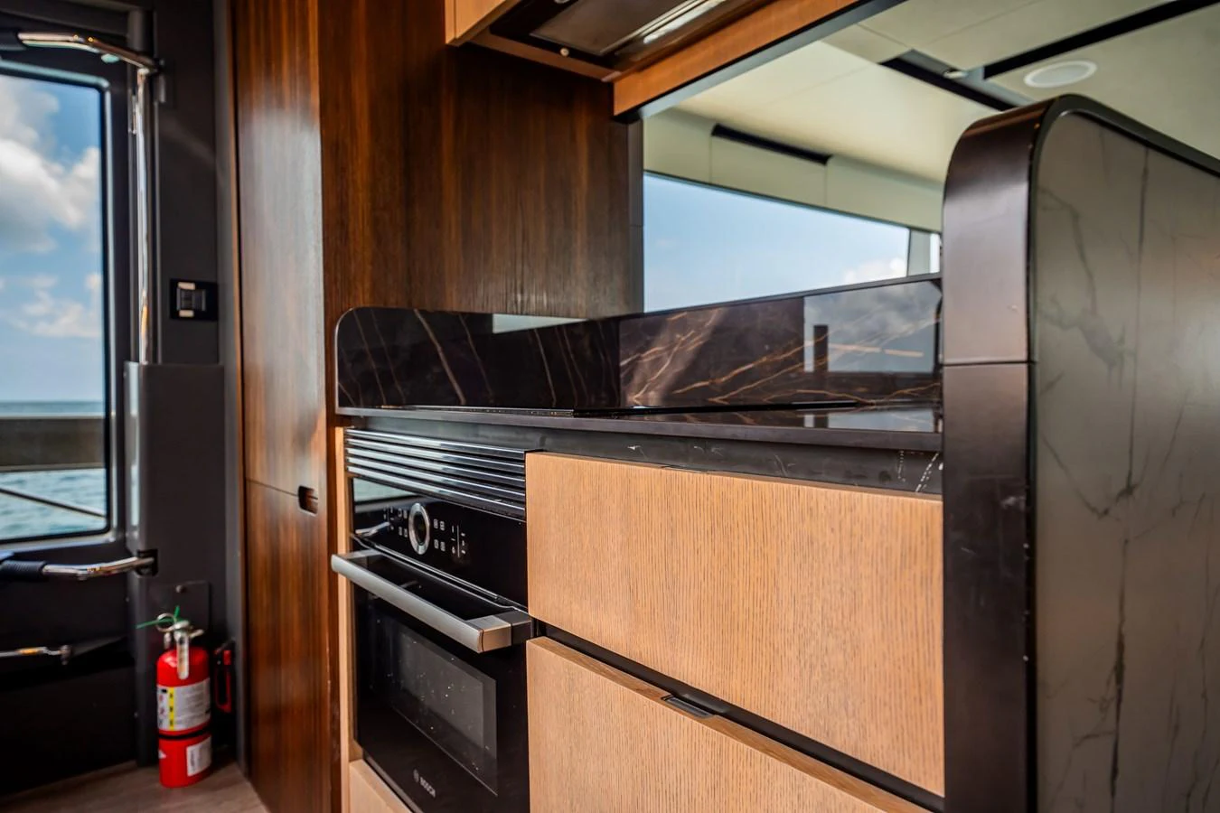 The yacht's galley features modern appliances and a sleek design with a view of the sea. aboard HOTEL COLLECTION Yacht for Sale