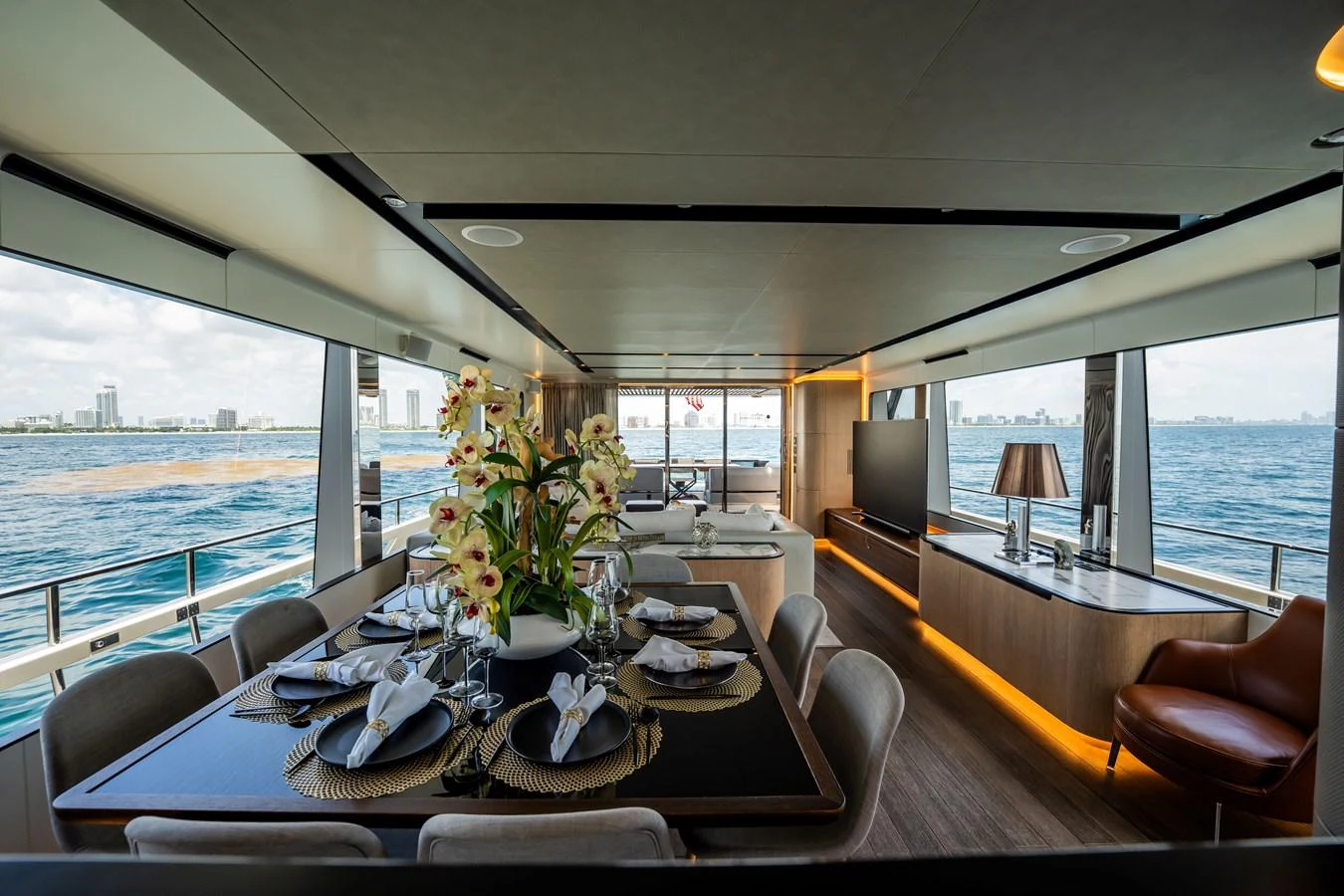 The yacht's dining area features elegant table settings and panoramic ocean views. aboard HOTEL COLLECTION Yacht for Sale