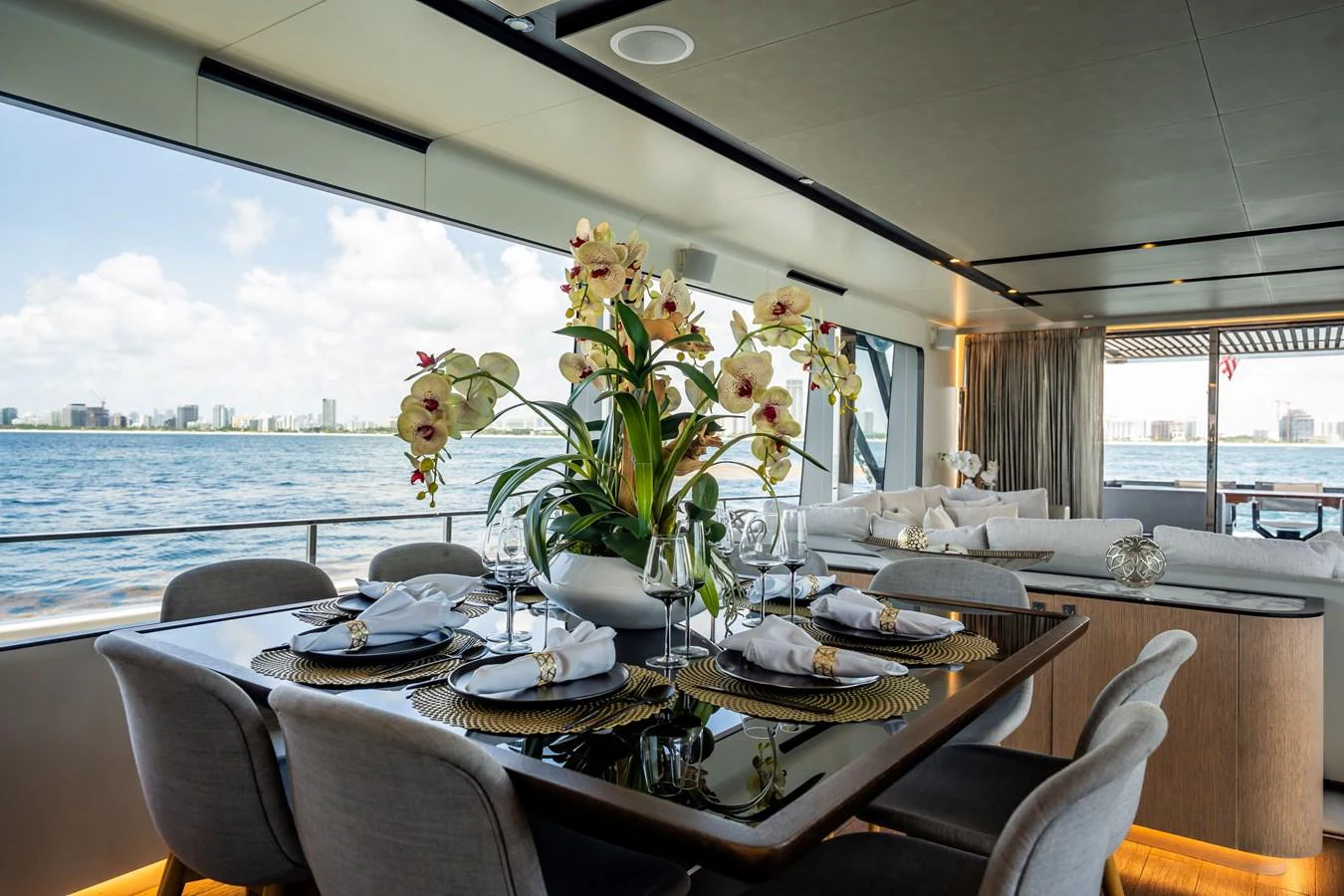 The yacht's dining area offers a luxurious setting with a stunning view of the water. aboard HOTEL COLLECTION Yacht for Sale