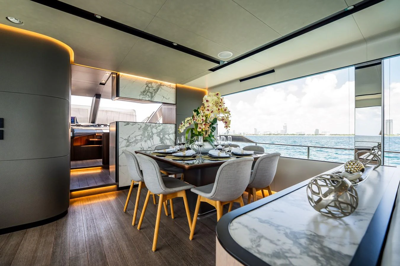 The yacht's dining area features a modern design with a large window offering stunning sea views. aboard HOTEL COLLECTION Yacht for Sale
