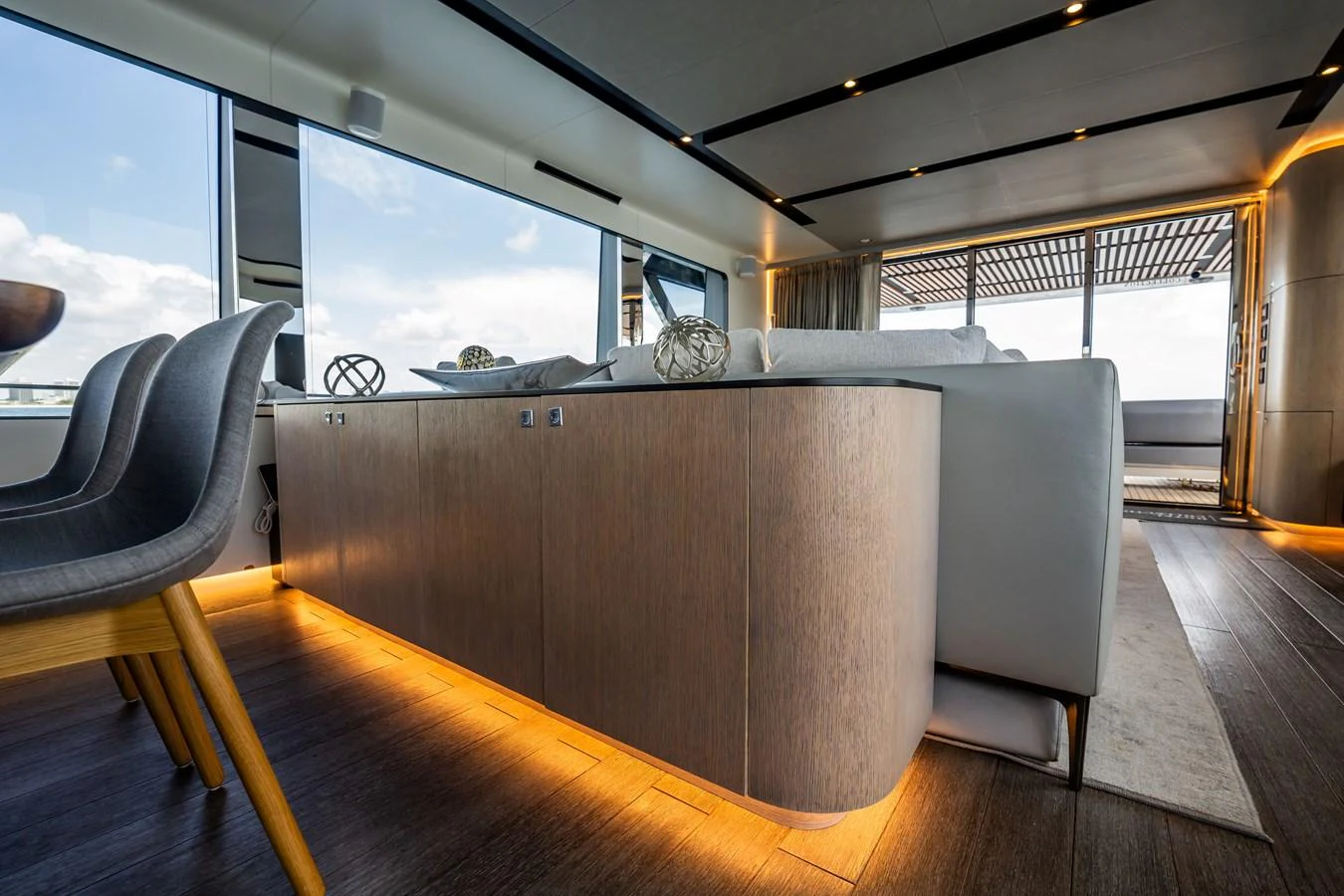 The salon features modern furnishings with ample natural light and elegant lighting accents. aboard HOTEL COLLECTION Yacht for Sale