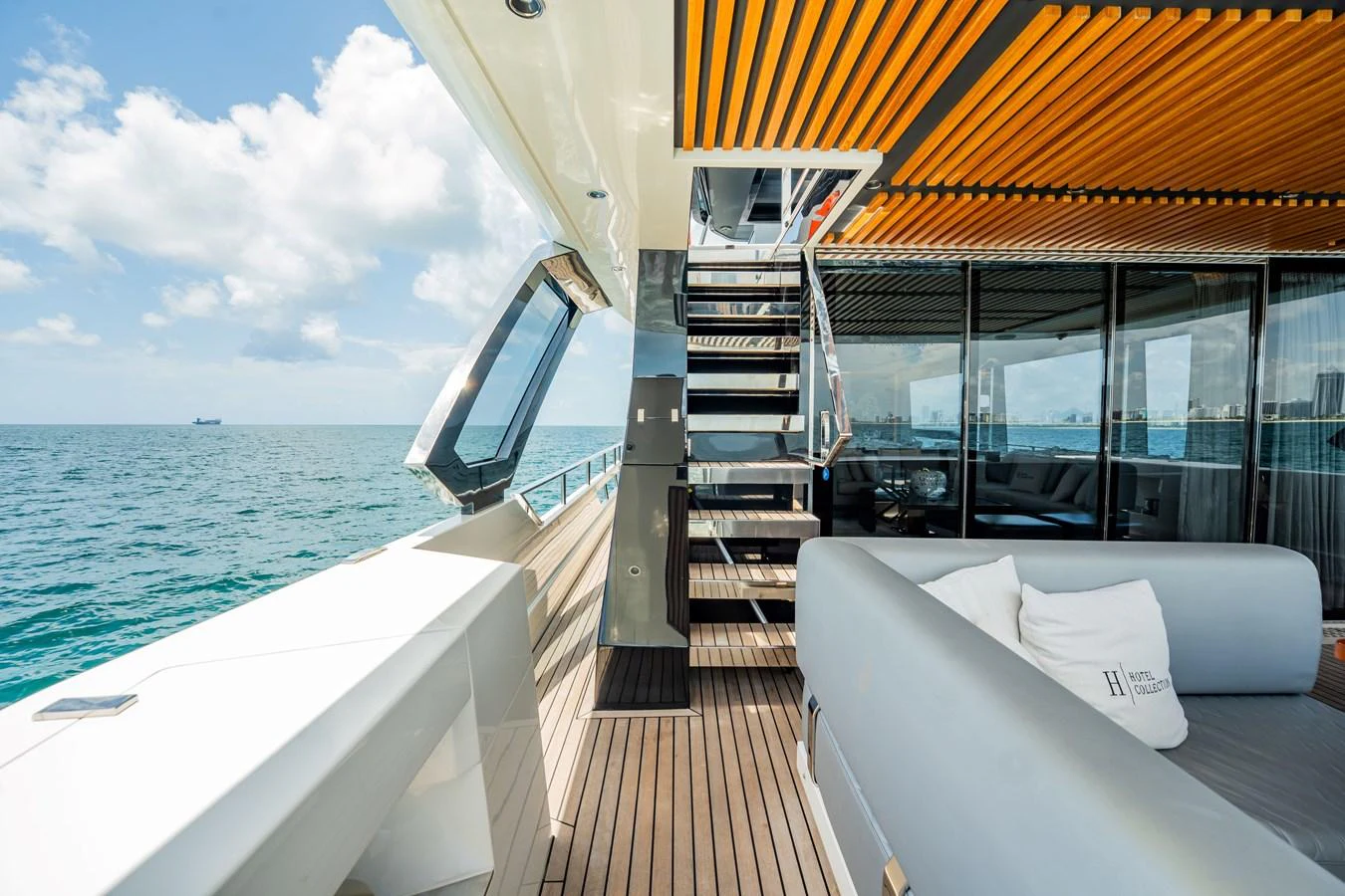 The aft deck offers a luxurious space with comfortable seating and a stunning view of the ocean. aboard HOTEL COLLECTION Yacht for Sale