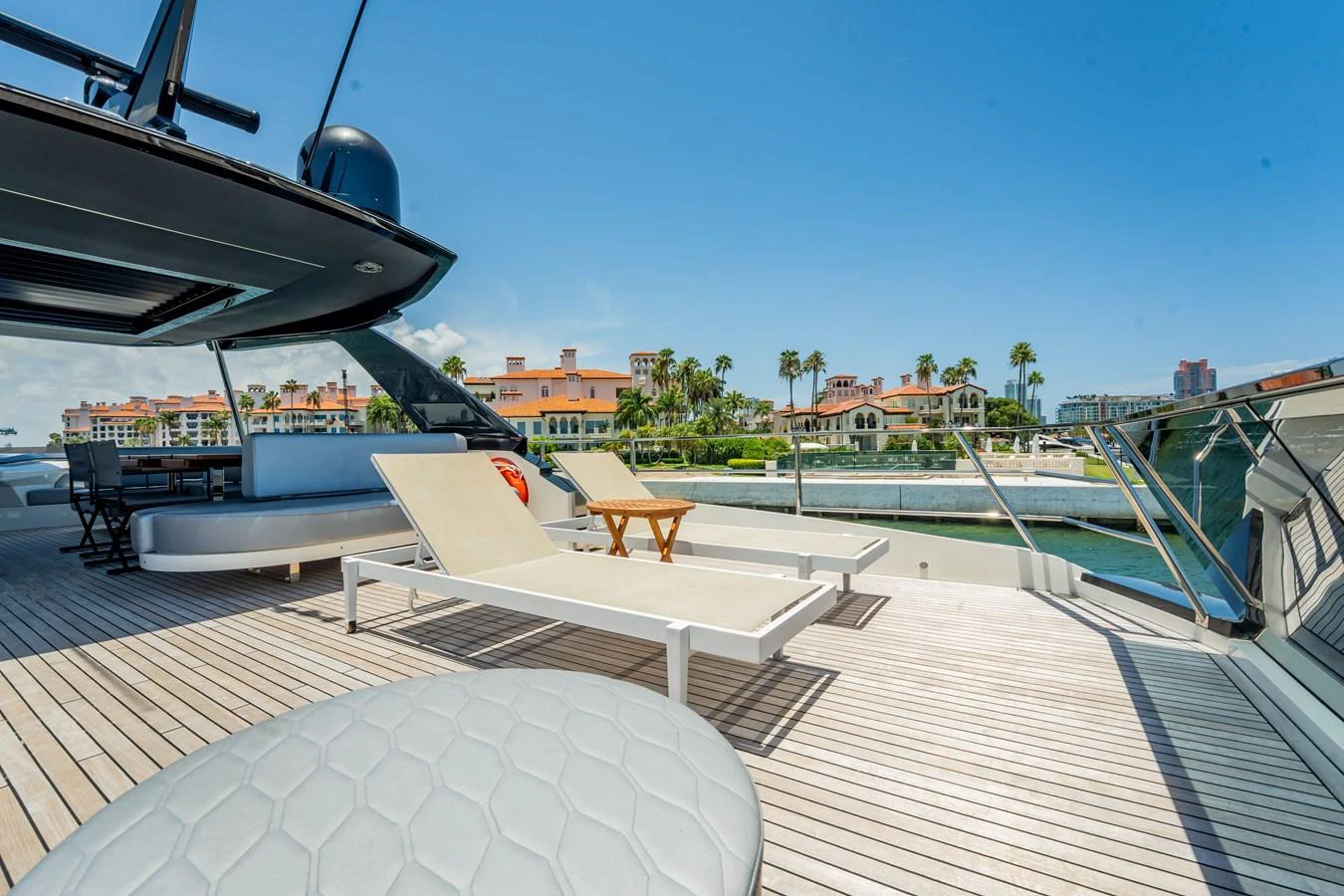 The sundeck offers a luxurious space for relaxation with sun loungers and a stunning view of the waterfront. aboard HOTEL COLLECTION Yacht for Sale