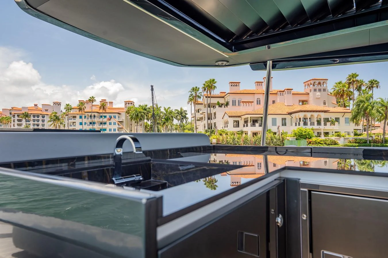 A sleek outdoor kitchen area on the yacht, featuring a modern grill and polished surfaces. aboard HOTEL COLLECTION Yacht for Sale