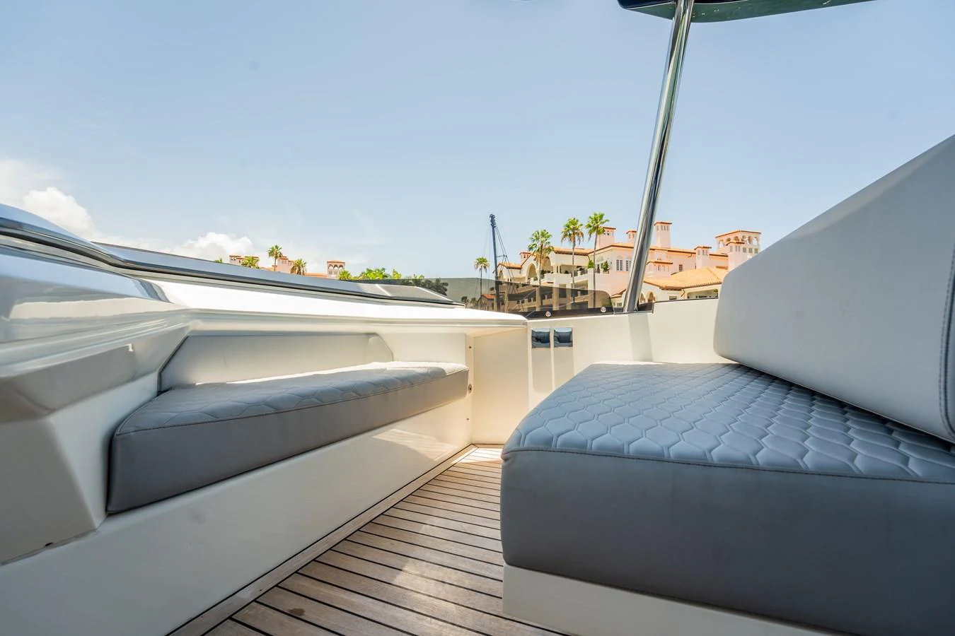 The yacht features a comfortable seating area with cushioned benches and a view of the surroundings. aboard HOTEL COLLECTION Yacht for Sale