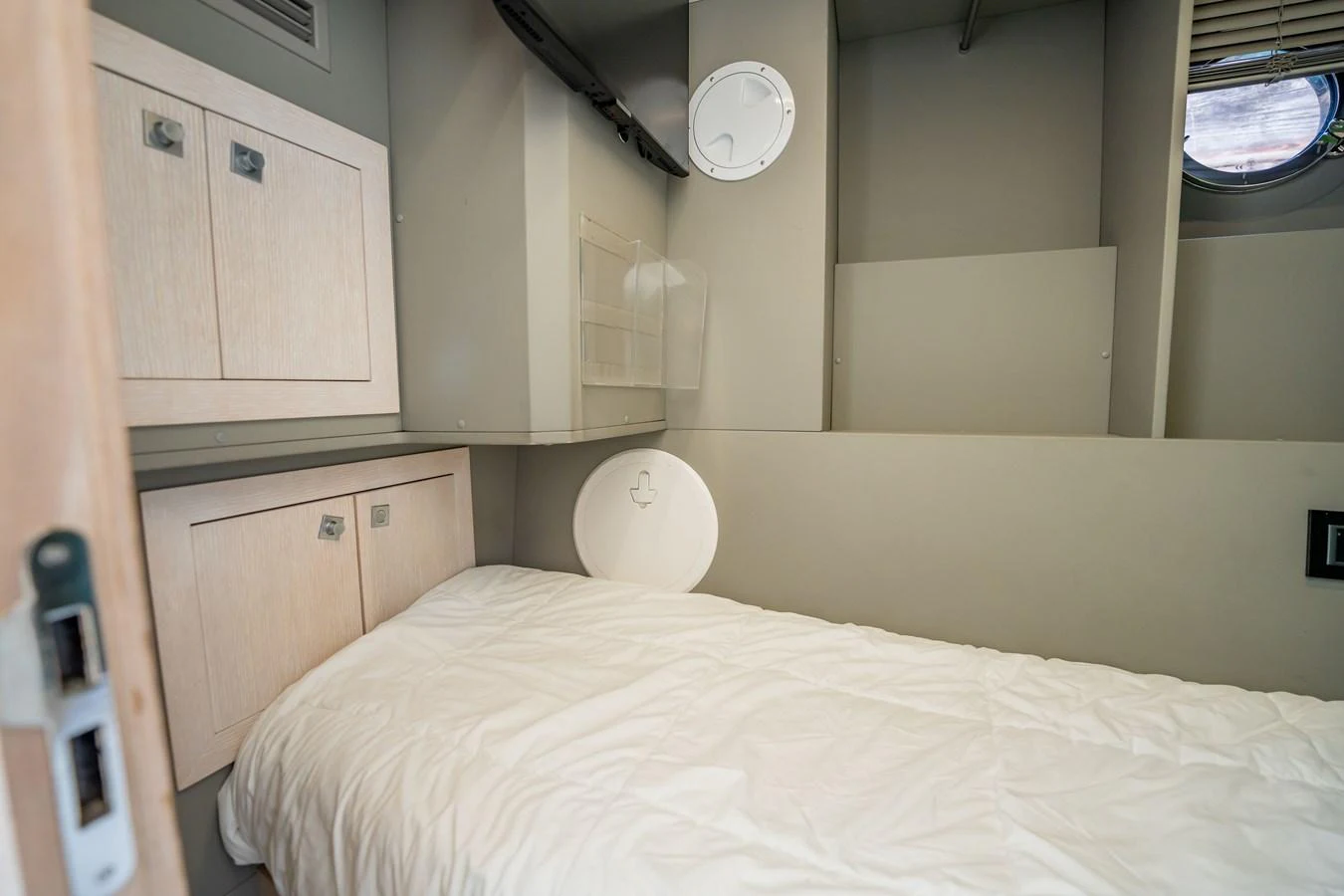 A cozy cabin with a single bed and storage cabinets, perfect for a restful night at sea. aboard HOTEL COLLECTION Yacht for Sale