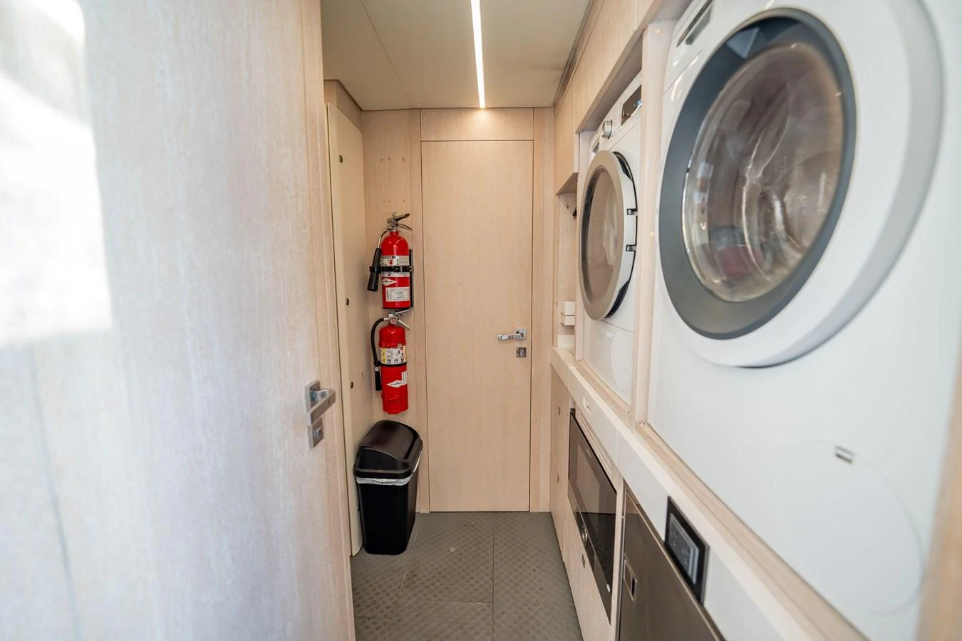 The yacht's laundry room is equipped with modern appliances and essential safety equipment. aboard HOTEL COLLECTION Yacht for Sale