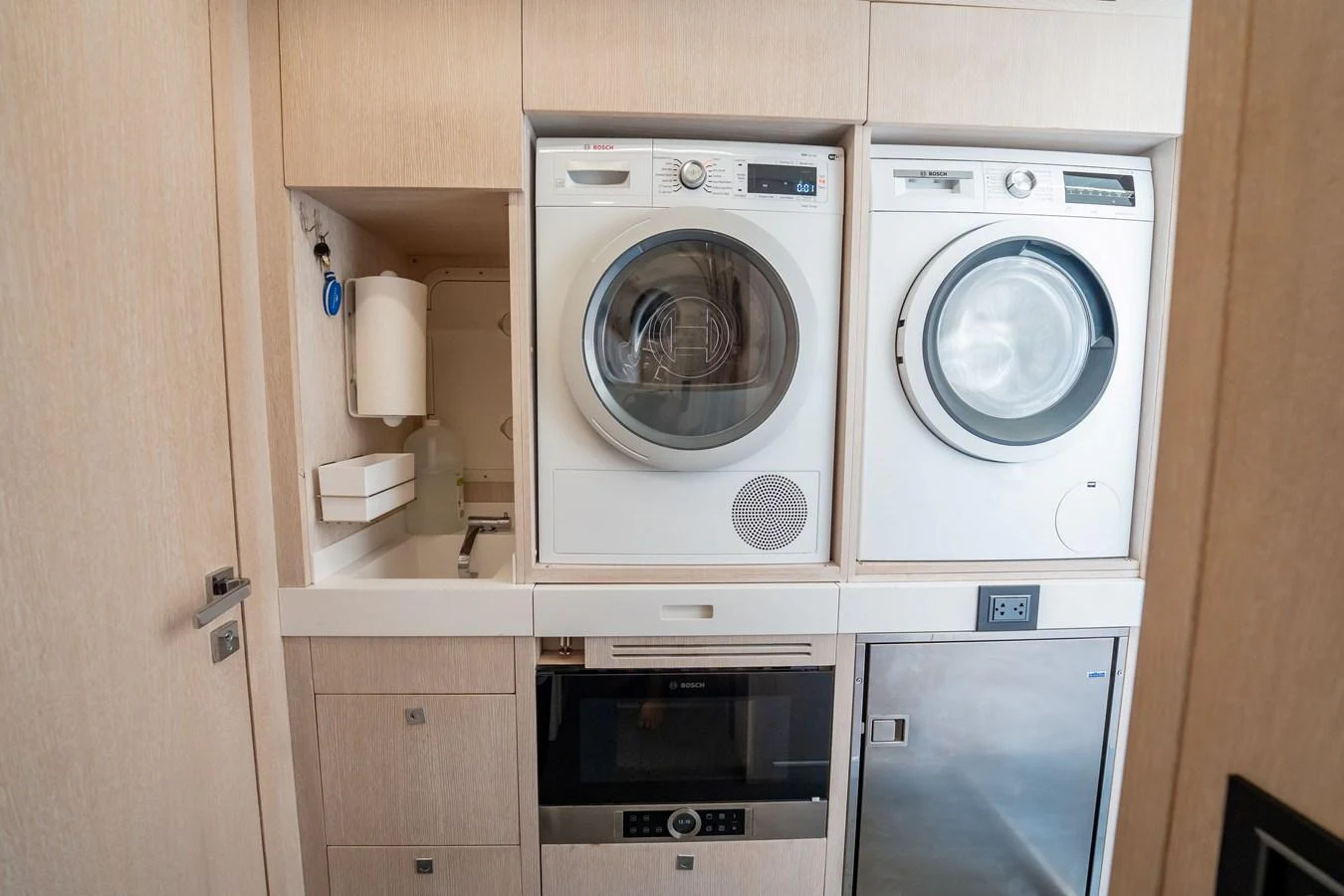 The yacht features a compact and efficient laundry area with modern appliances. aboard HOTEL COLLECTION Yacht for Sale