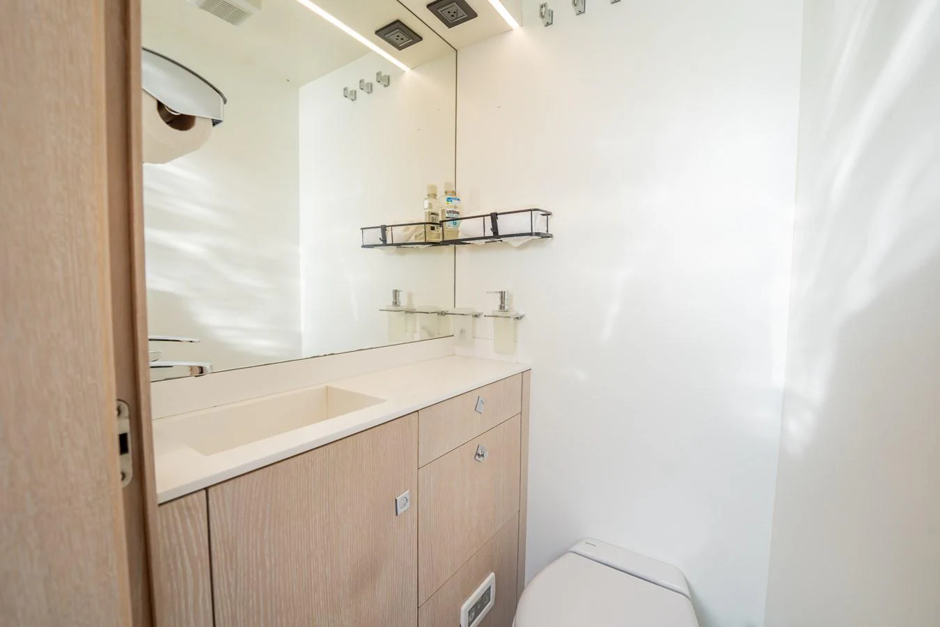 A modern yacht bathroom with sleek fixtures and ample storage. aboard HOTEL COLLECTION Yacht for Sale