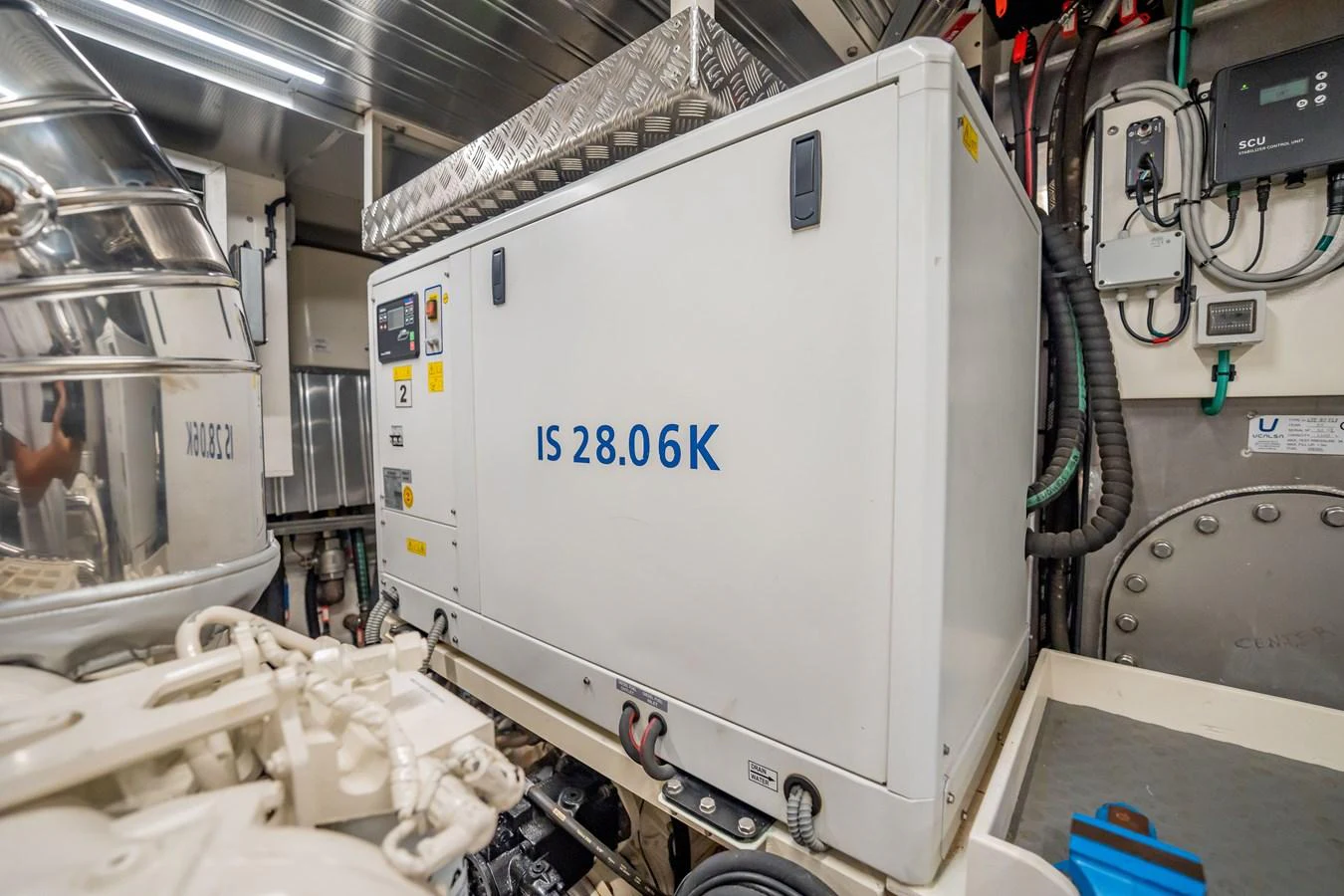 The image showcases the yacht's engine room with a focus on the generator unit. aboard HOTEL COLLECTION Yacht for Sale