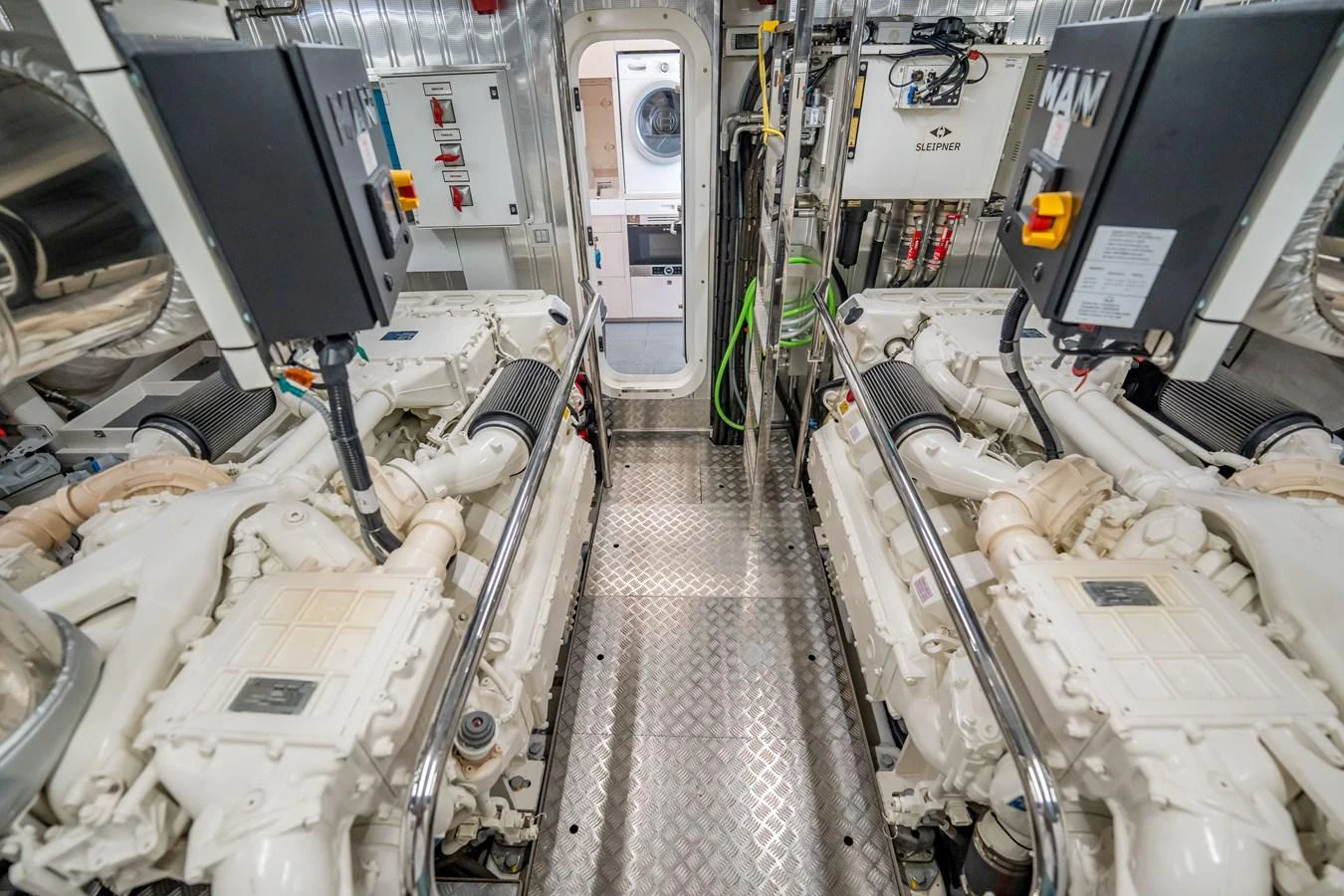 The engine room showcases powerful machinery and a clean, organized layout. aboard HOTEL COLLECTION Yacht for Sale