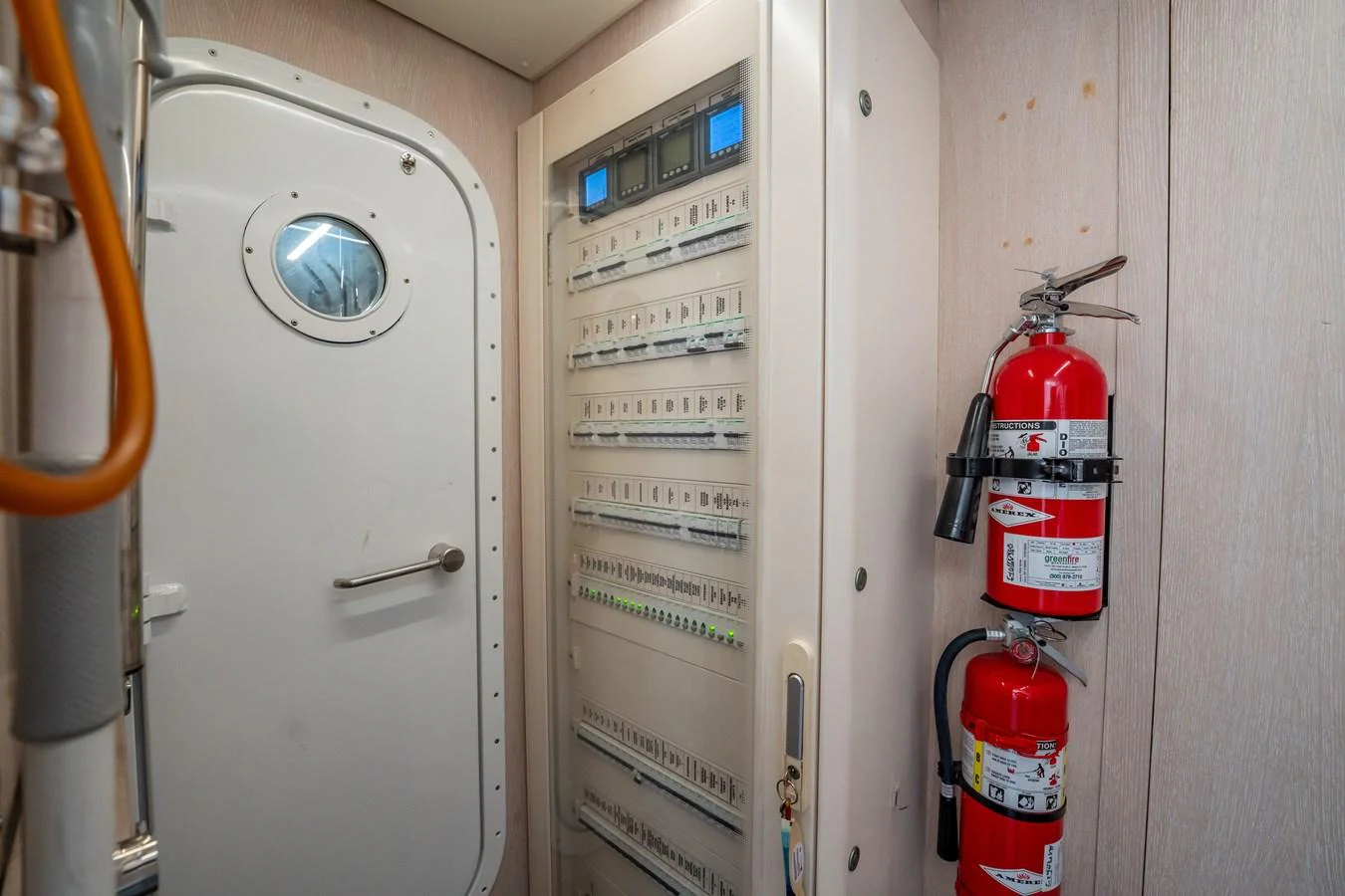 A detailed view of the yacht's control room with fire extinguishers and control panels. aboard HOTEL COLLECTION Yacht for Sale