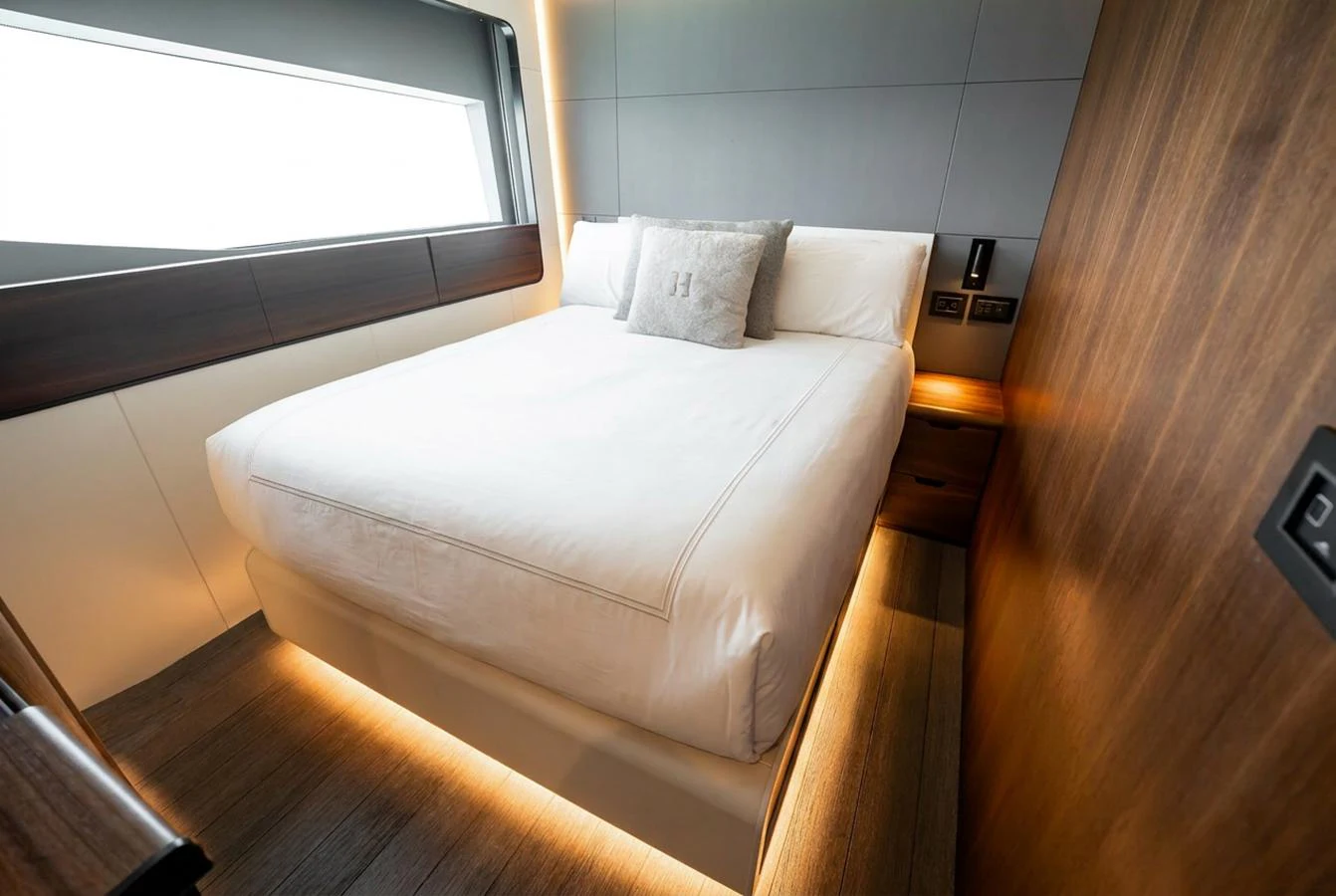 A cozy stateroom with a large bed and modern design elements. aboard HOTEL COLLECTION Yacht for Sale