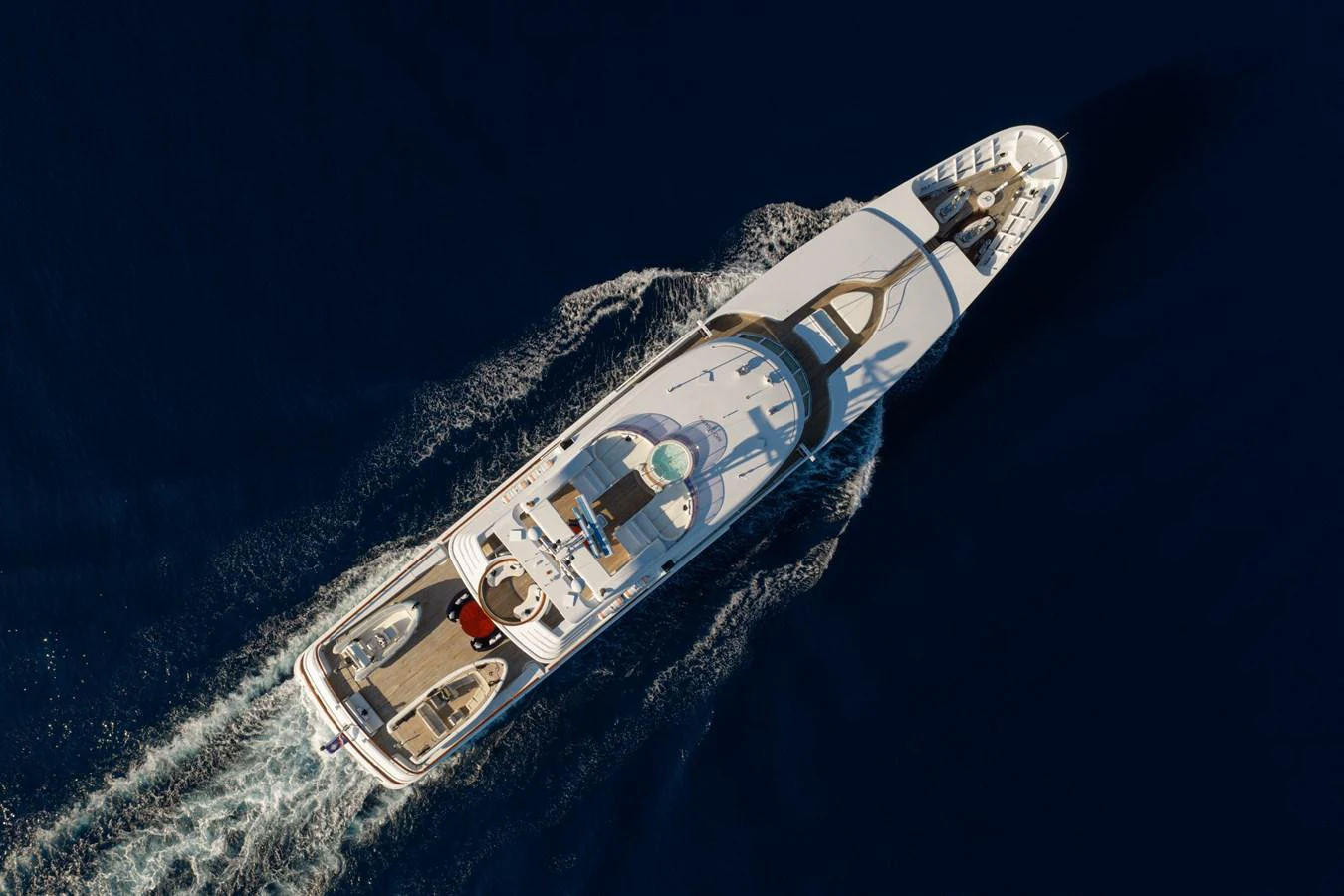 An aerial view of a luxurious yacht cruising through deep blue waters. aboard MY LADY Yacht for Sale