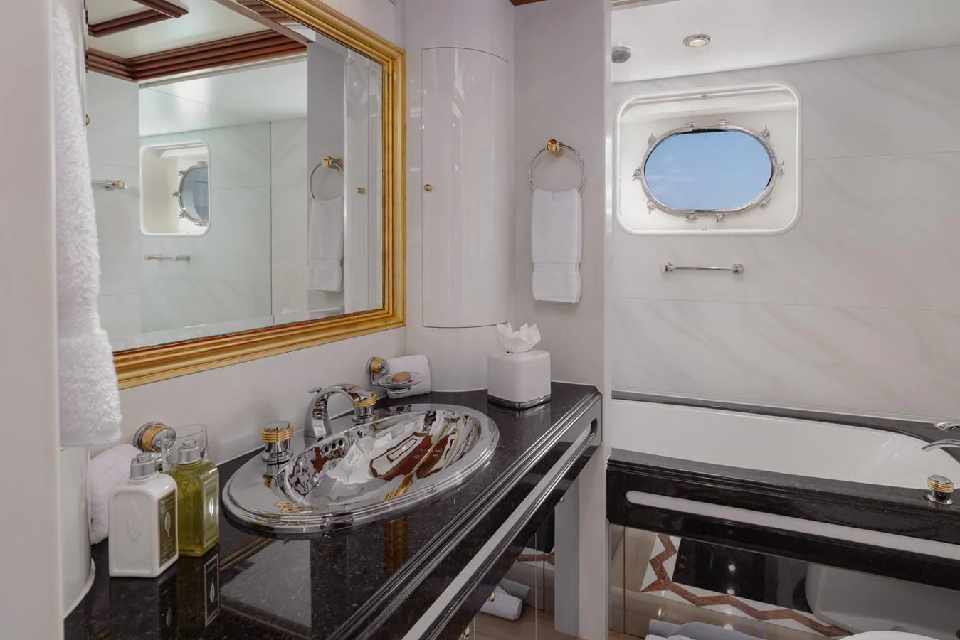 The yacht's bathroom features elegant fixtures and a porthole window for natural light. aboard MY LADY Yacht for Sale