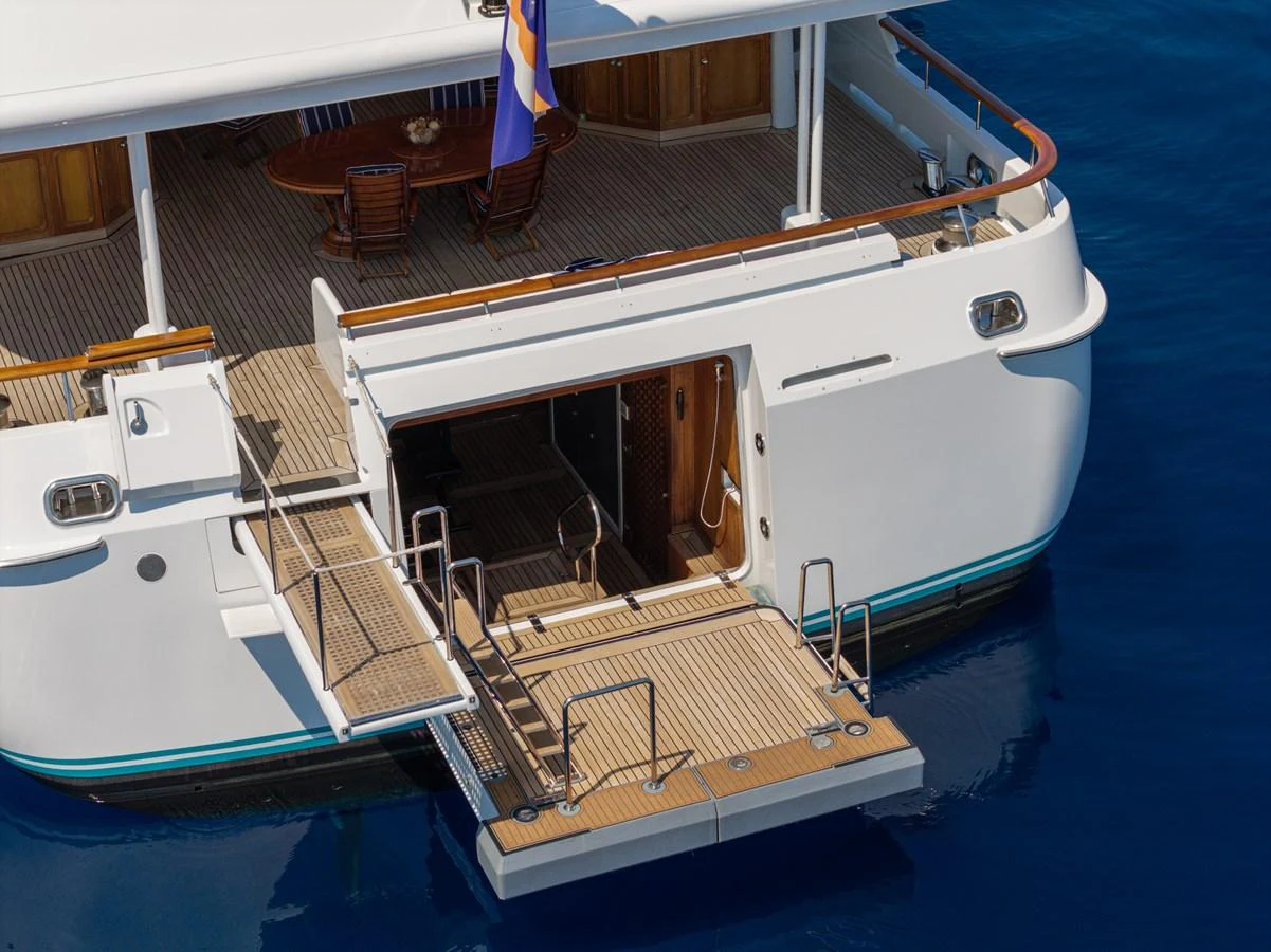 The yacht's aft deck features a swim platform and a fold-out boarding ladder, perfect for easy water access. aboard MY LADY Yacht for Sale