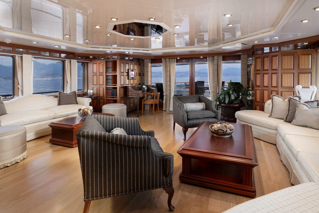 The spacious salon features elegant furnishings and panoramic windows offering stunning sea views. aboard MY LADY Yacht for Sale