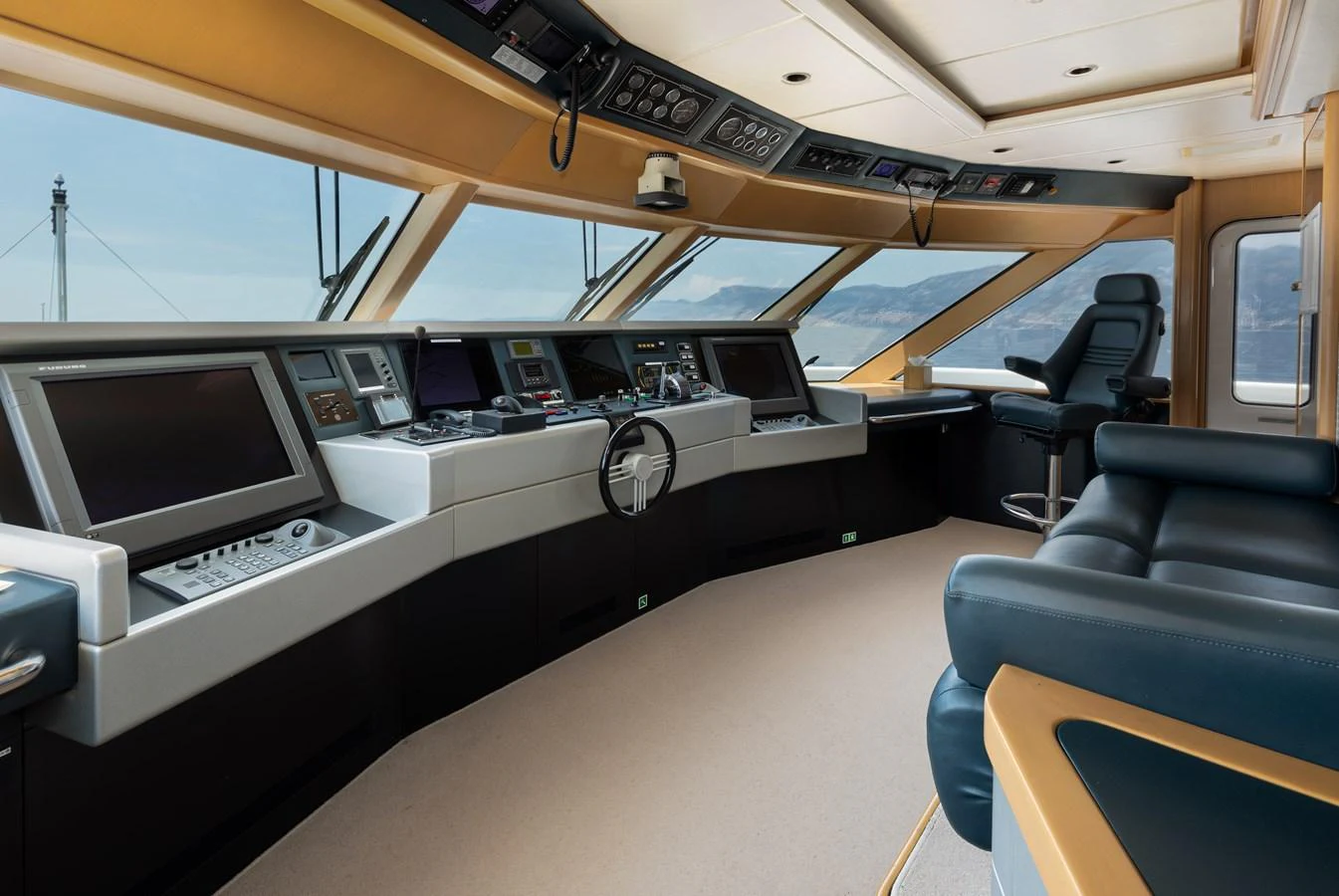 The helm station offers a commanding view with state-of-the-art navigation equipment and luxurious seating. aboard MY LADY Yacht for Sale