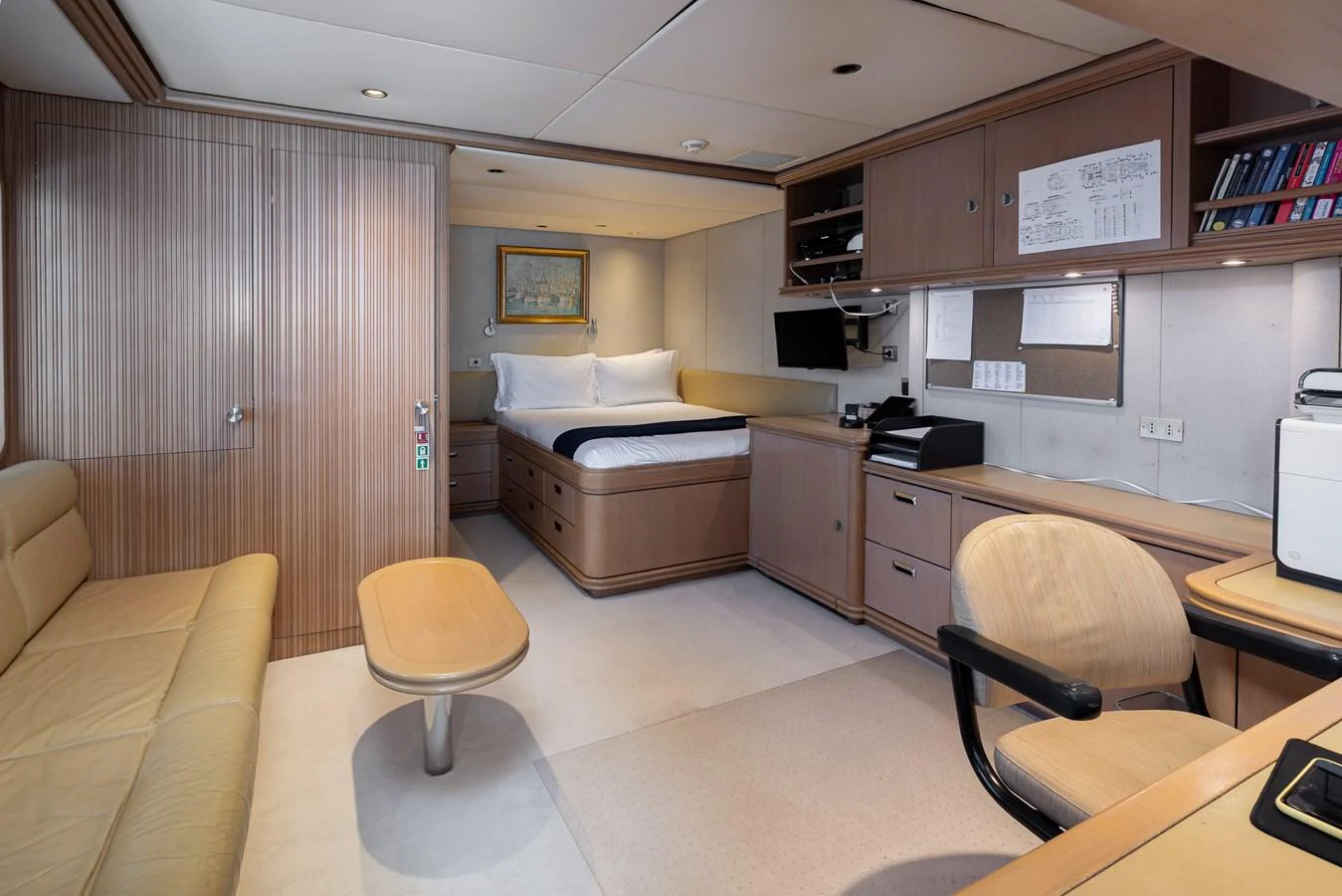 A comfortable and well-appointed cabin featuring a bed, desk, and seating area. aboard MY LADY Yacht for Sale