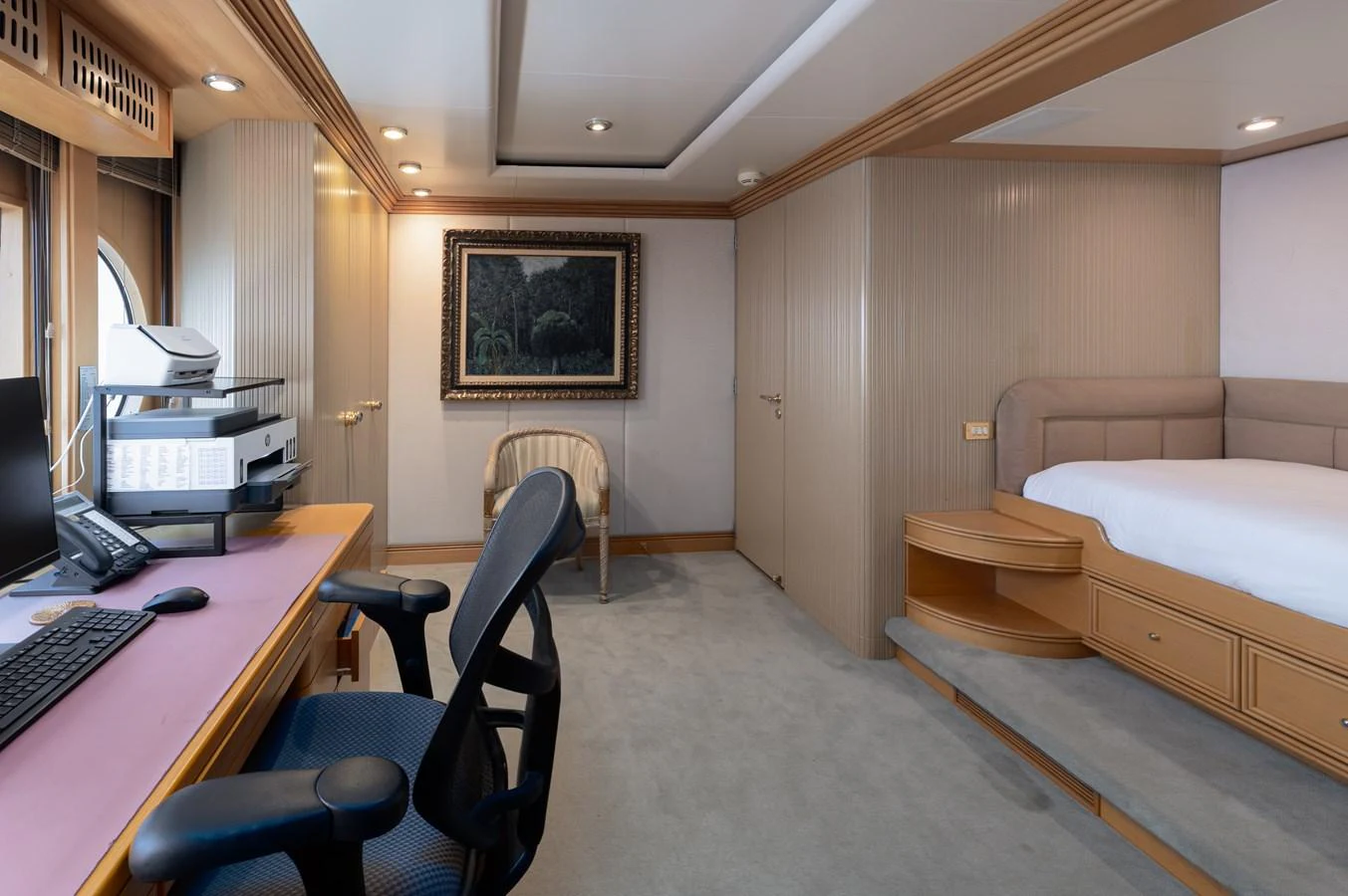 The stateroom features a comfortable bed, a work desk with office equipment, and elegant decor. aboard MY LADY Yacht for Sale