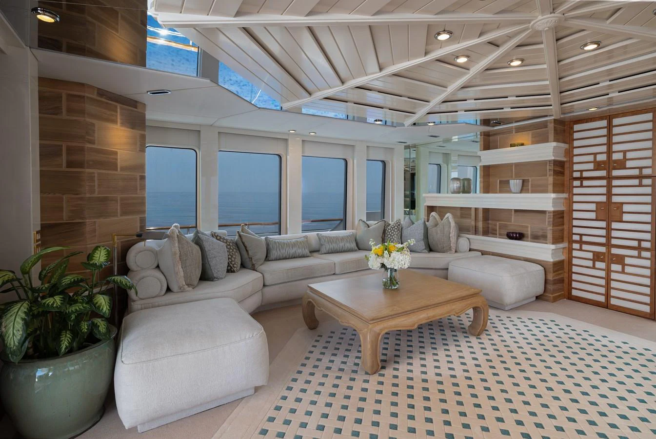 The salon features a spacious seating area with elegant decor and large windows offering stunning ocean views. aboard MY LADY Yacht for Sale