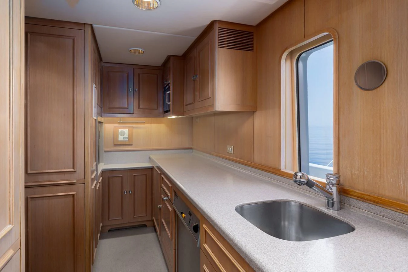 The galley features sleek wooden cabinetry and modern appliances, offering a functional and stylish space for meal preparation. aboard MY LADY Yacht for Sale