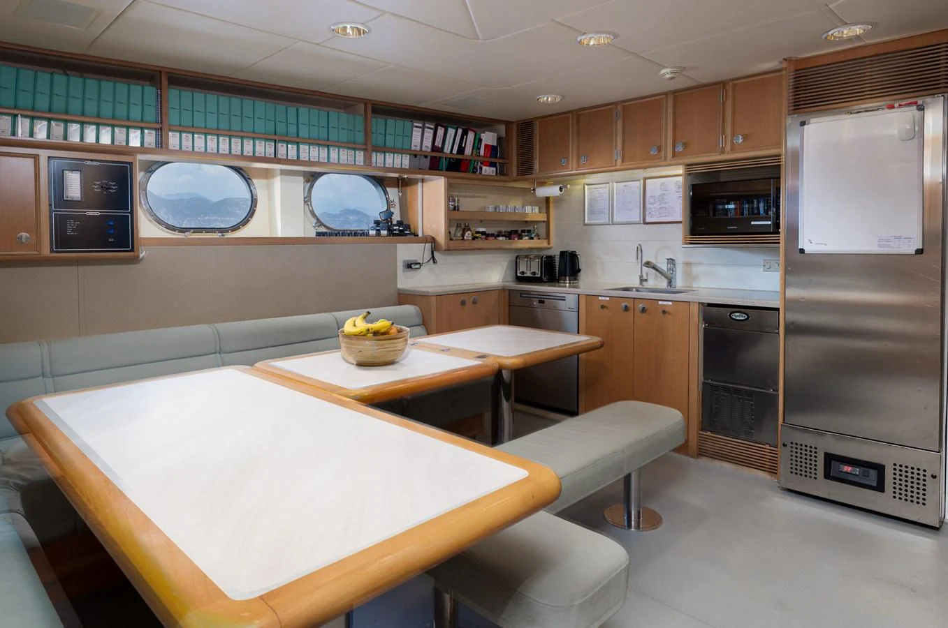The galley features a cozy dining area with ample seating and modern kitchen amenities. aboard MY LADY Yacht for Sale