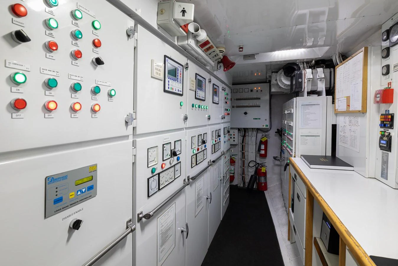 The yacht's engine room features a well-organized control panel with various gauges and switches. aboard MY LADY Yacht for Sale