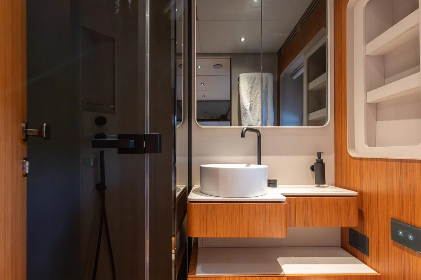 The yacht's bathroom features modern fixtures and elegant wood accents. aboard 2025 FERRETTI 670 KATRIN I Yacht for Sale